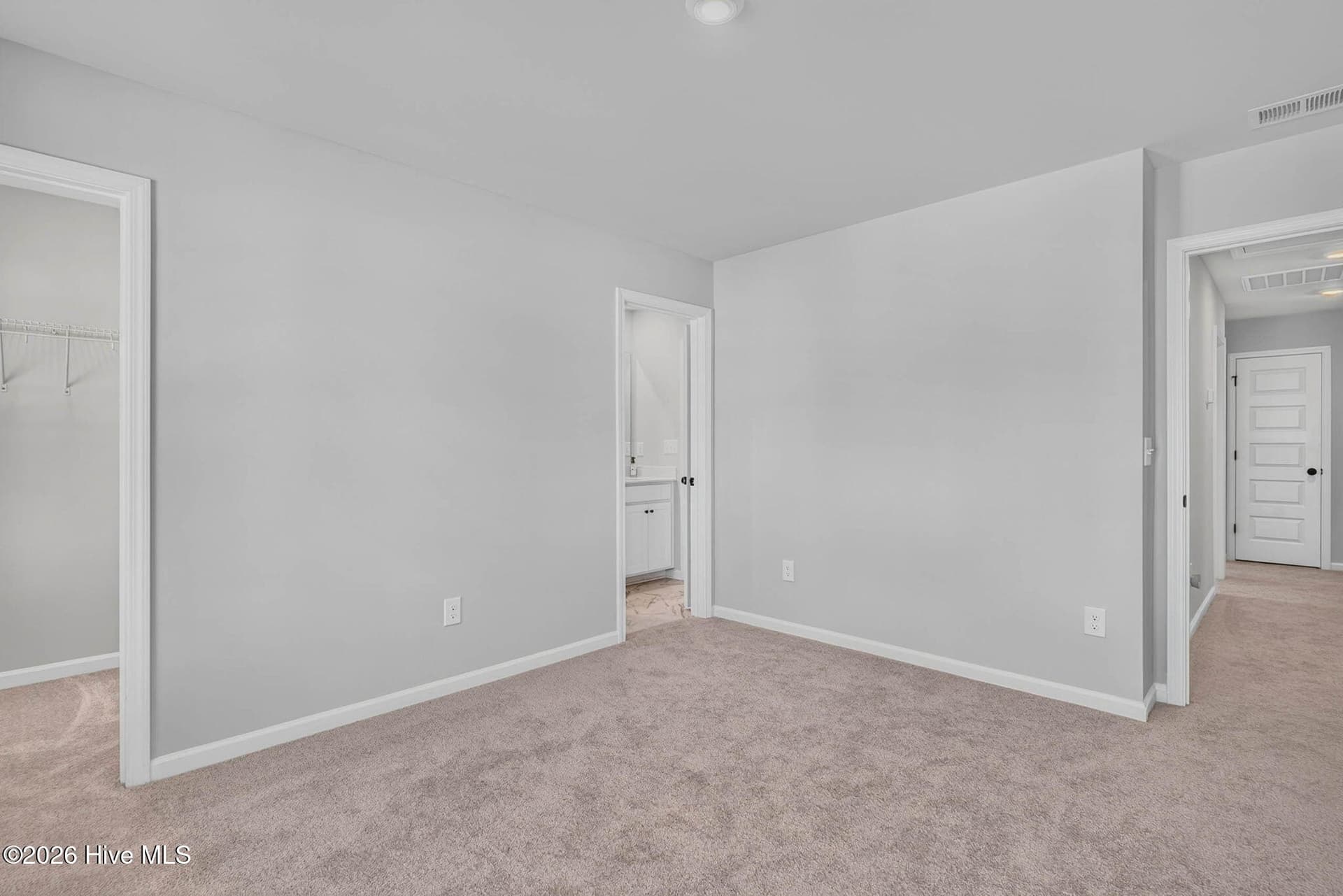 Additional view of the upstairs bedroom with neutral finishes and flexible living space. - 3447 Sandhill Crane Drive SW, Ocean Isle Beach, NC 28469