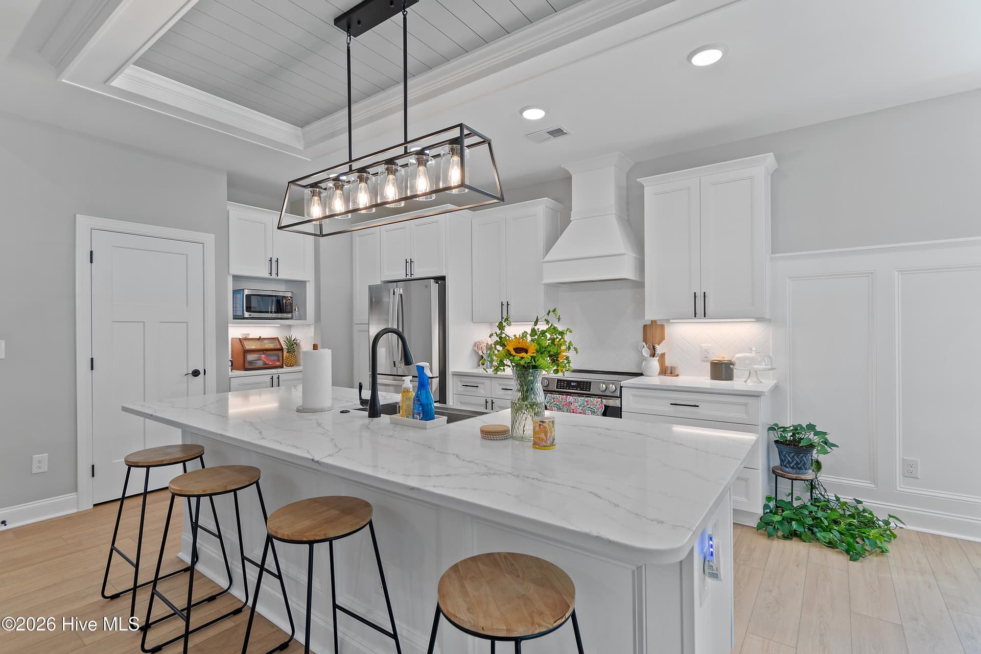 Quartz kitchen countertops, shiplap accents, high wainscotting. - 299 Boundaryline Drive NW, Calabash, NC 28467