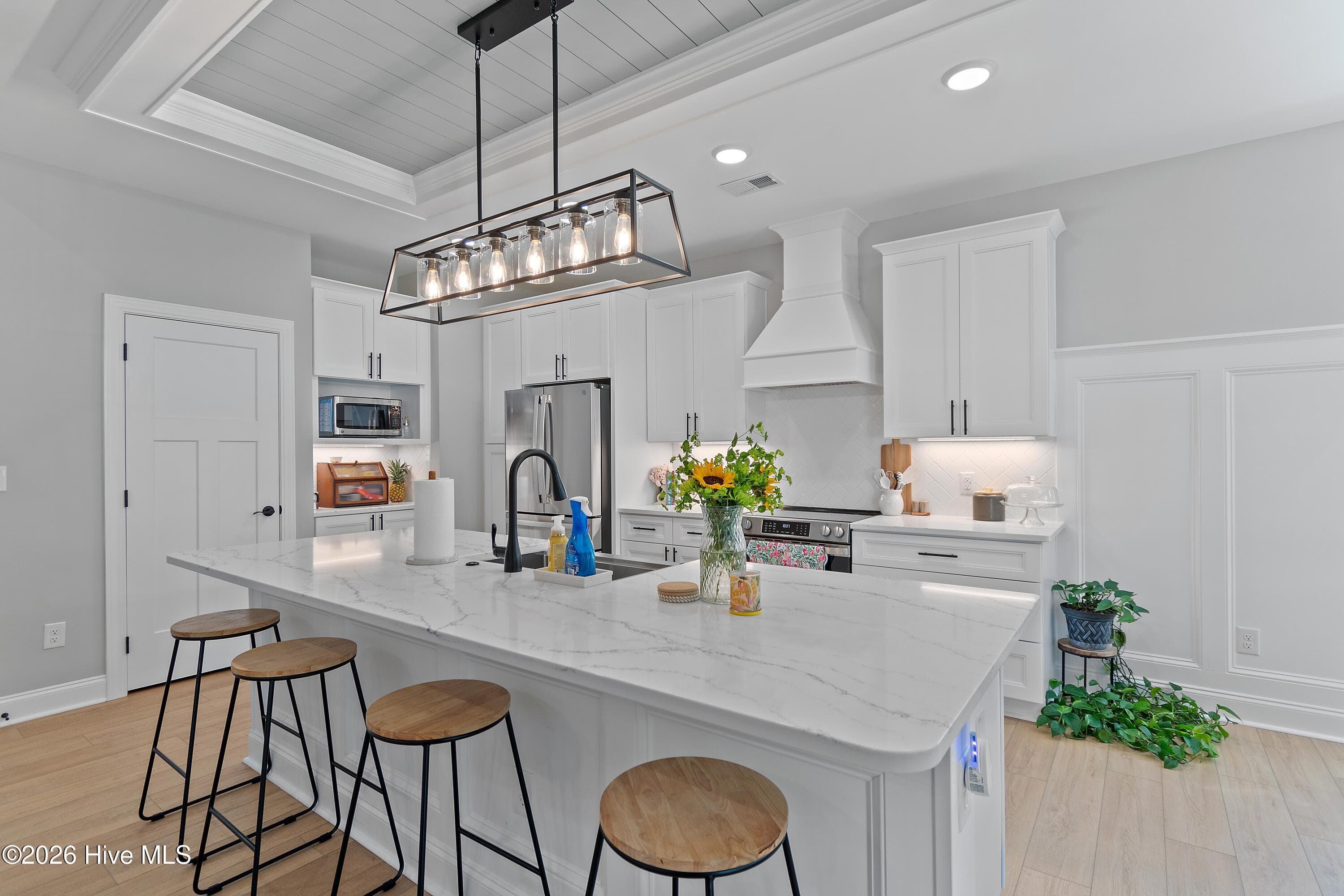 Quartz kitchen countertops, shiplap accents, high wainscotting. - 299 Boundaryline Drive NW, Calabash, NC 28467