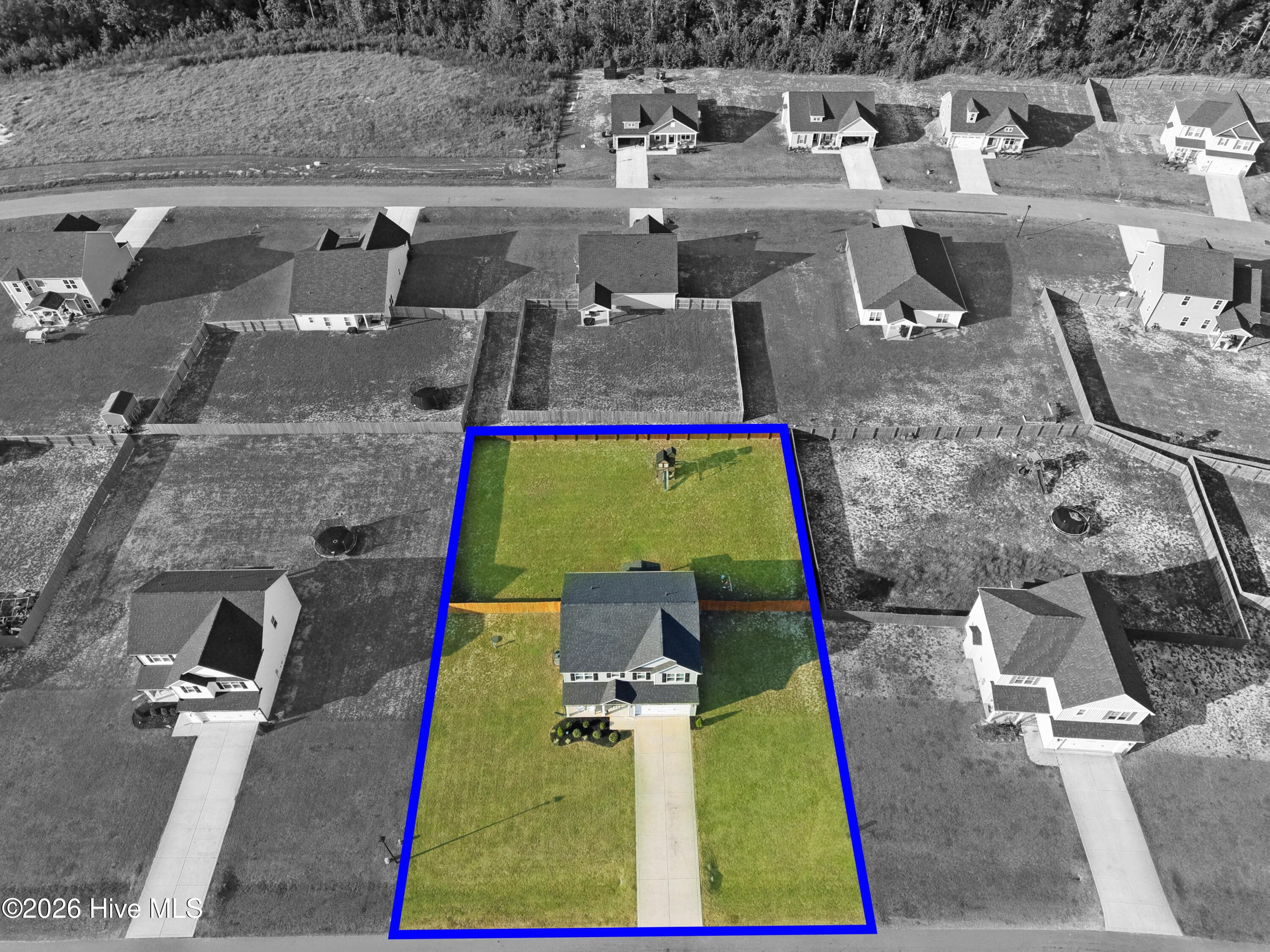 High aerial perspective of 221 Vega Lane in Linden, NC, providing additional context for the home's approximately 0.46-acre lot, fenced backyard, playground area, neighboring homes, and Collier Gate surroundings. Image has been virtually enhanced, including selective color treatment, to illustrate the subject property's general location and relationship to surrounding properties. Boundary indicators shown are approximate, are not a survey, and should not be relied upon to establish legal property lines. Buyers are encouraged to obtain a survey or otherwise independently verify boundaries as part of their due diligence. - 221 Vega Lane, Linden, NC 28356