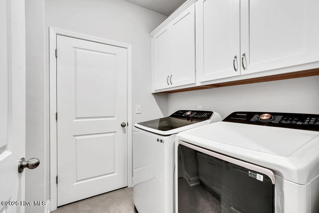 This pass-through laundry room features a built-in folding station and connects one of the owner's suite walk-in closets to the entryway. - 142 Rice Marsh Way, Wilmington, NC 28412
