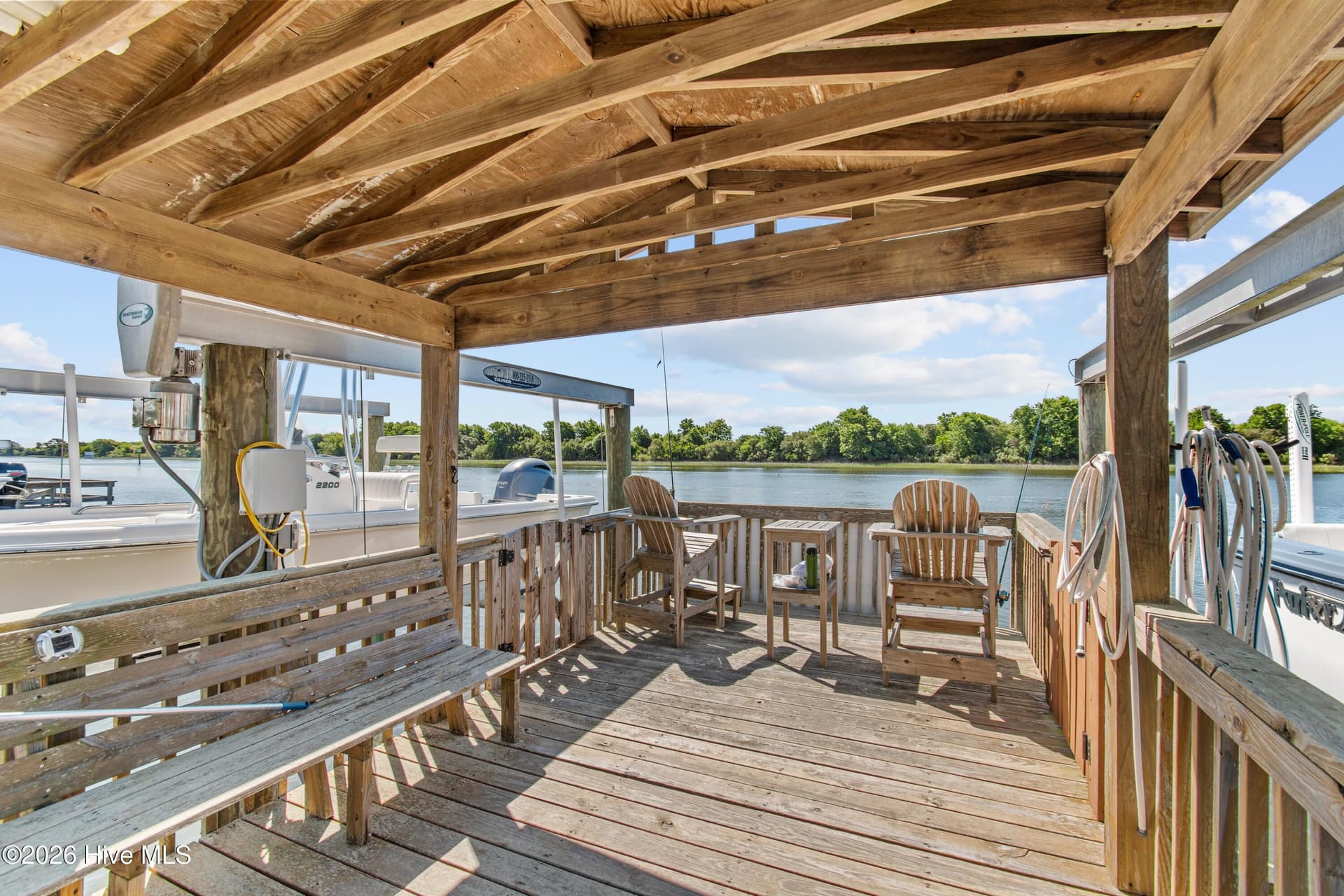 Large gazebo at the end of the well-maintained dock with 2 boat lifts. - 2024 Camelot Drive SW, Ocean Isle Beach, NC 28469
