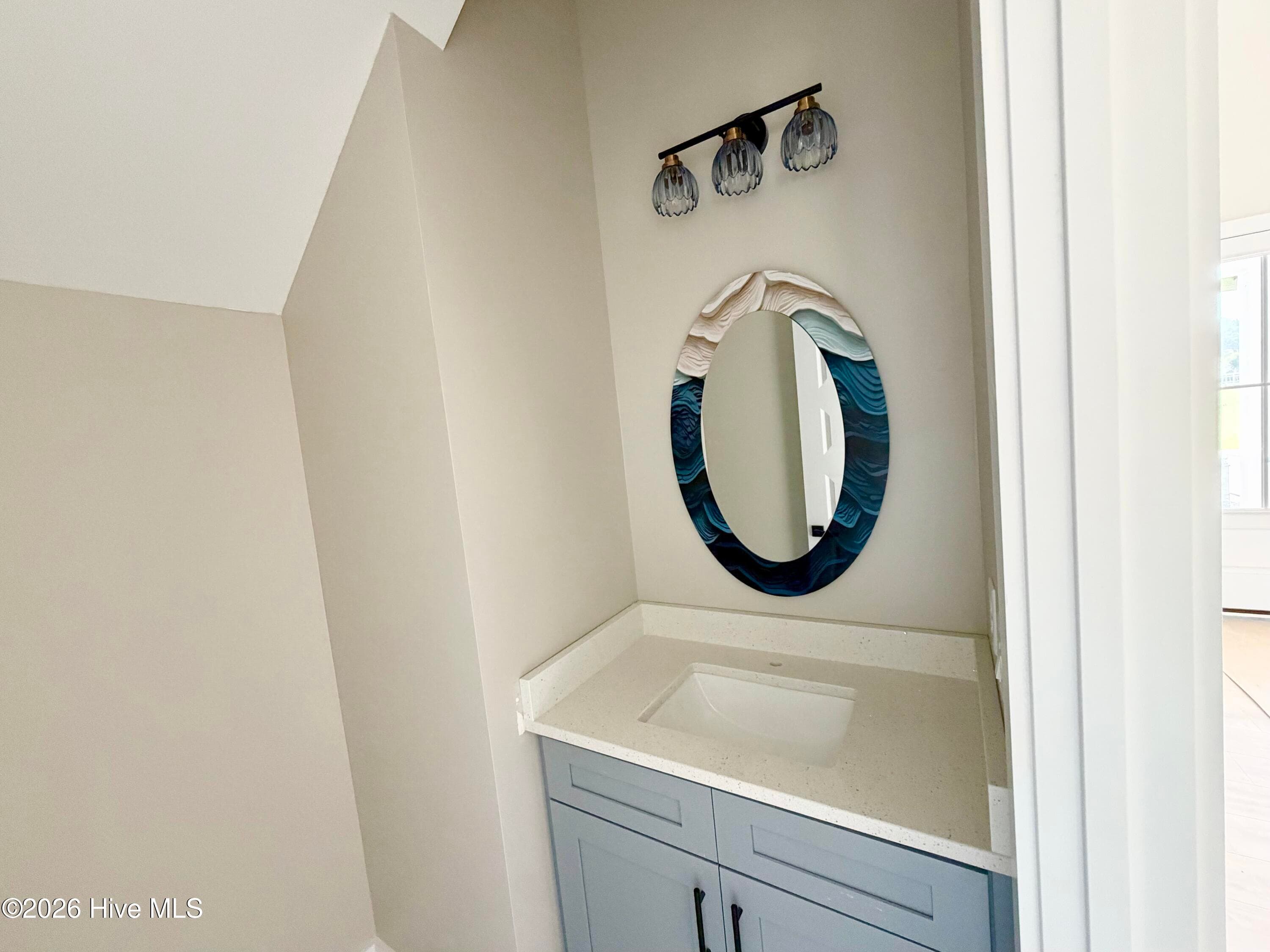Powder room half bath, custom mirror and lighting. - 550 Glenburnie Street NW, Calabash, NC 28467