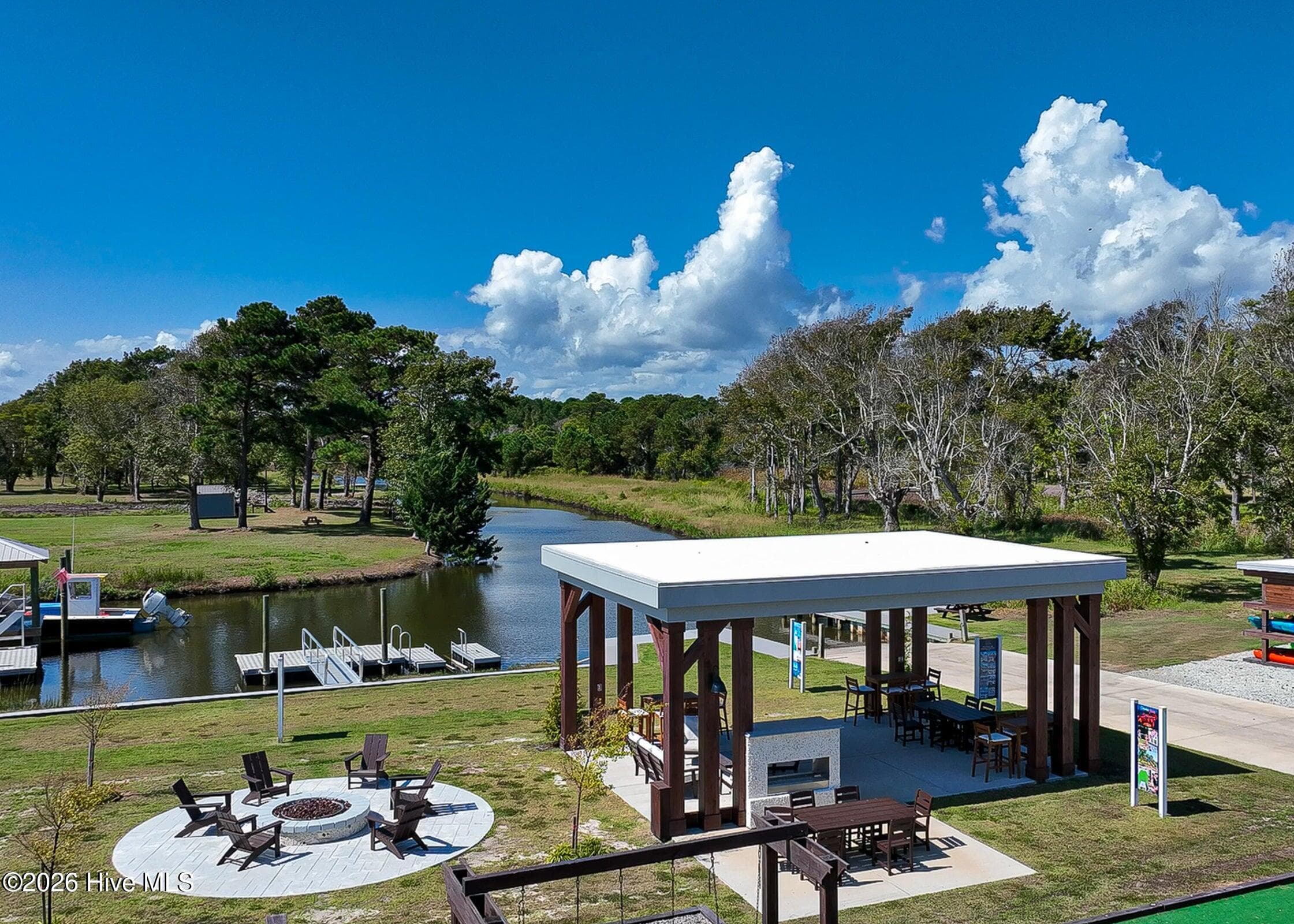 Amenities include pavilion, kayak storage, fire pit, corn hole, and boat ramp, and kayak launch - 208 River Oats Court, Holly Ridge, NC 28445