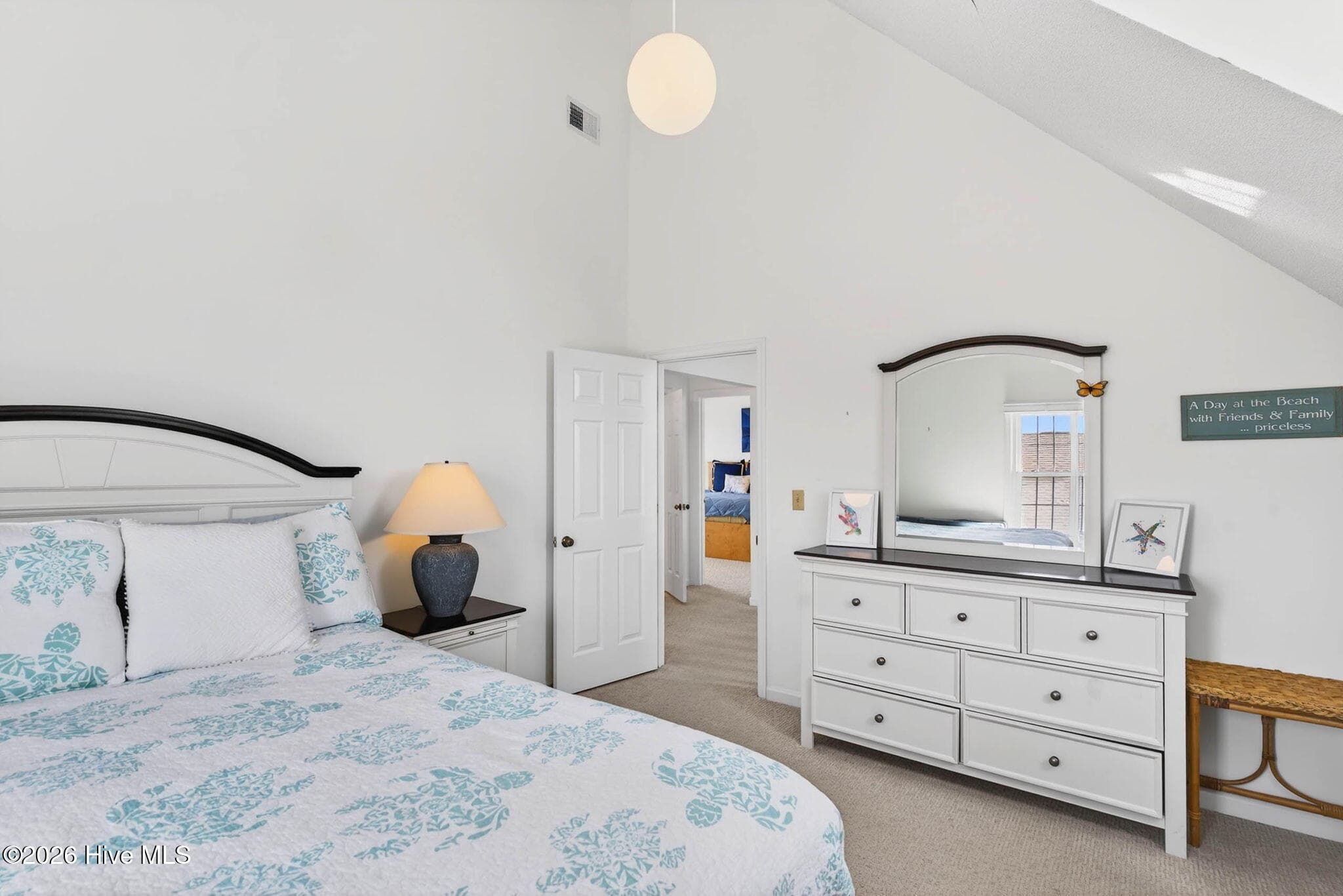 Large bedroom with ample floor space, neutral finishes, and great storage potential. - 1206 N Shore Drive W, Sunset Beach, NC 28468