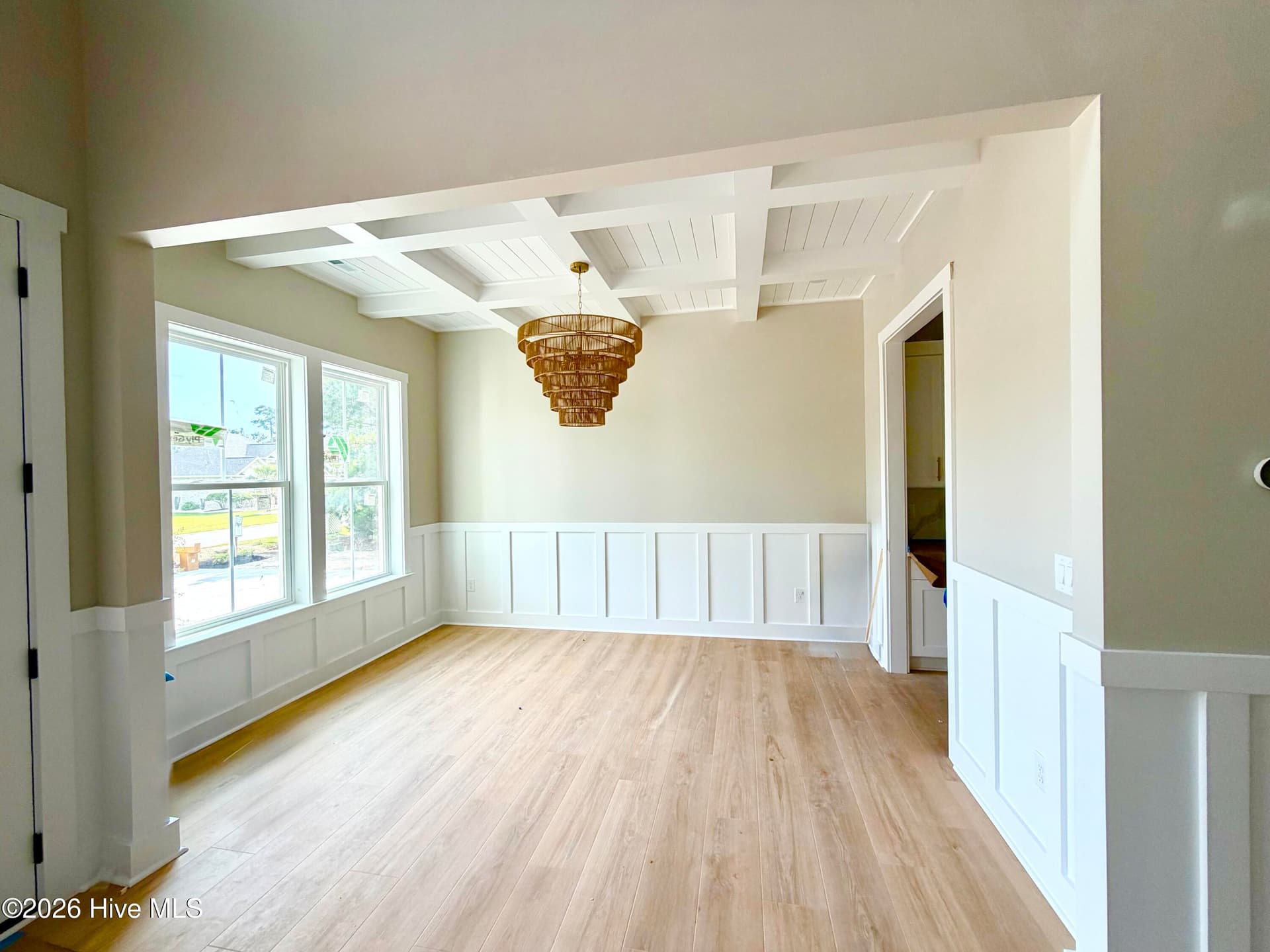 Dining room with custom lighting, wainscoting and coffered ceiling, under construction. - 550 Glenburnie Street NW, Calabash, NC 28467