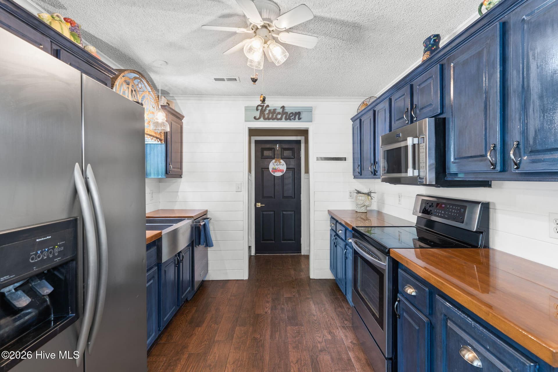 Kitchen. Doorway to upstairs, garage, or back to foyer - 9184 Seaside Landing SW, Calabash, NC 28467