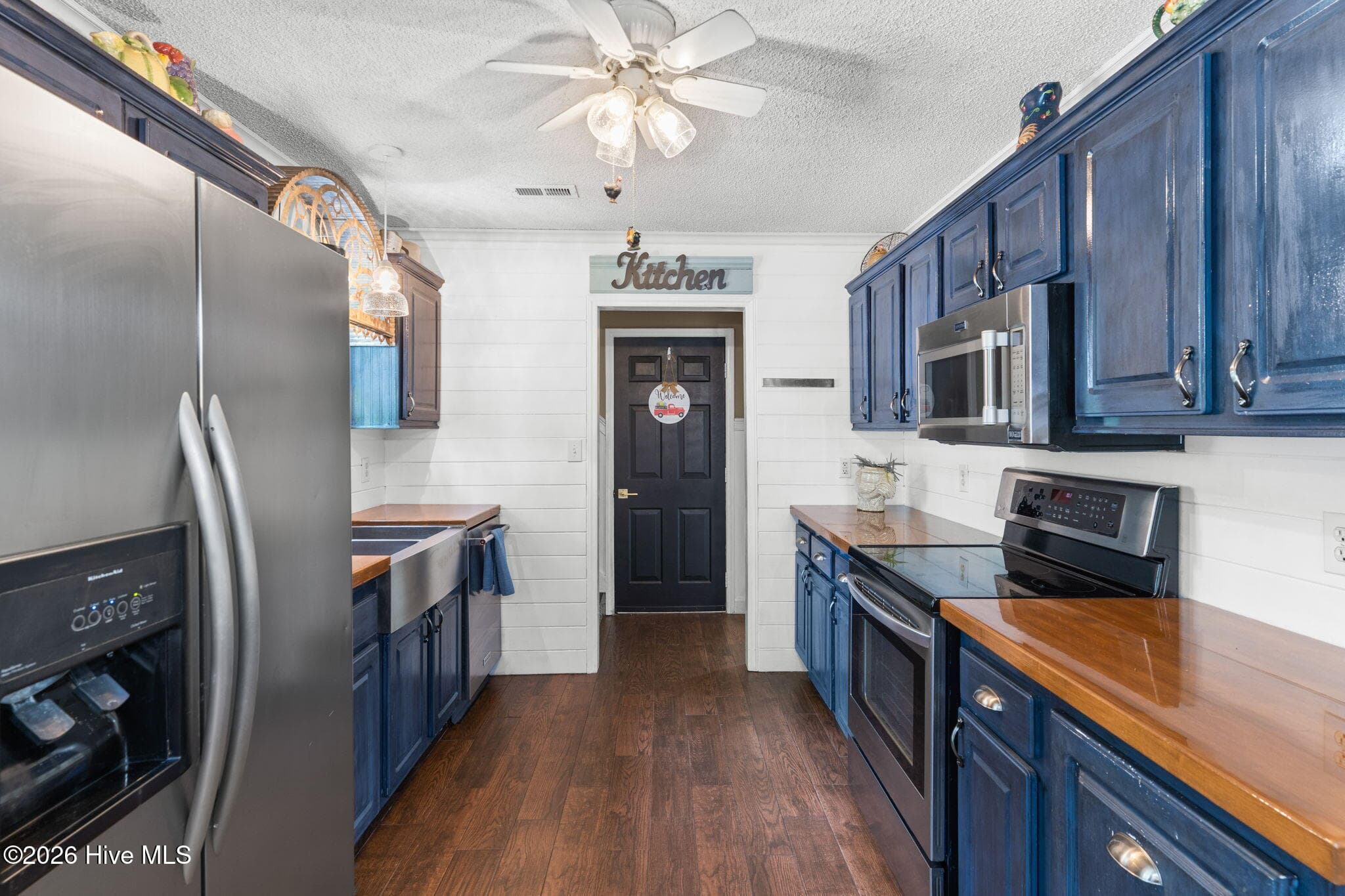 Kitchen. Doorway to upstairs, garage, or back to foyer - 9184 Seaside Landing SW, Calabash, NC 28467