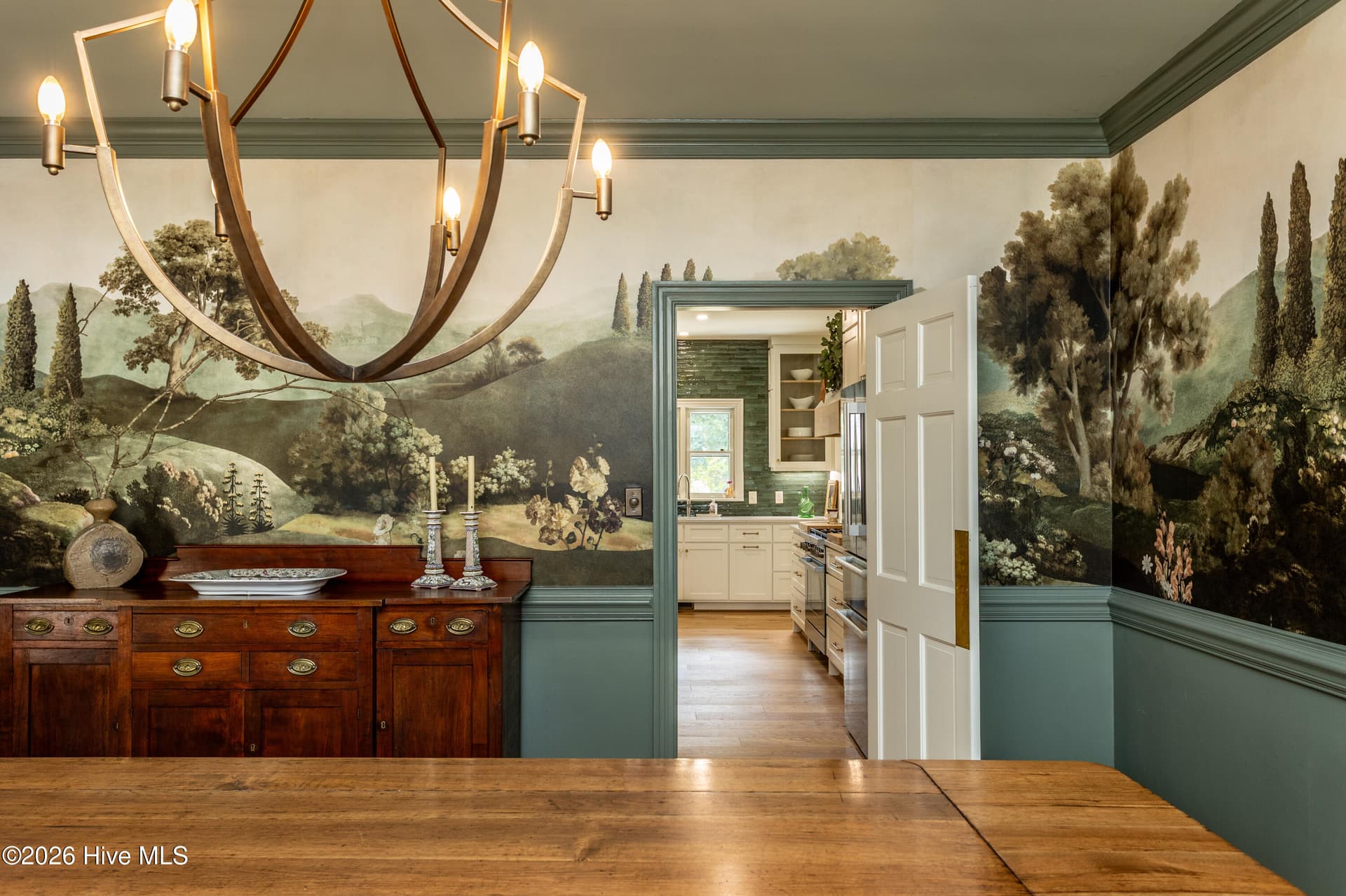 Old World Charm in this large dining room with beautiful wallpaper mural and fabulous chandelier. - 5050 Country Club Drive N, Wilson, NC 27896