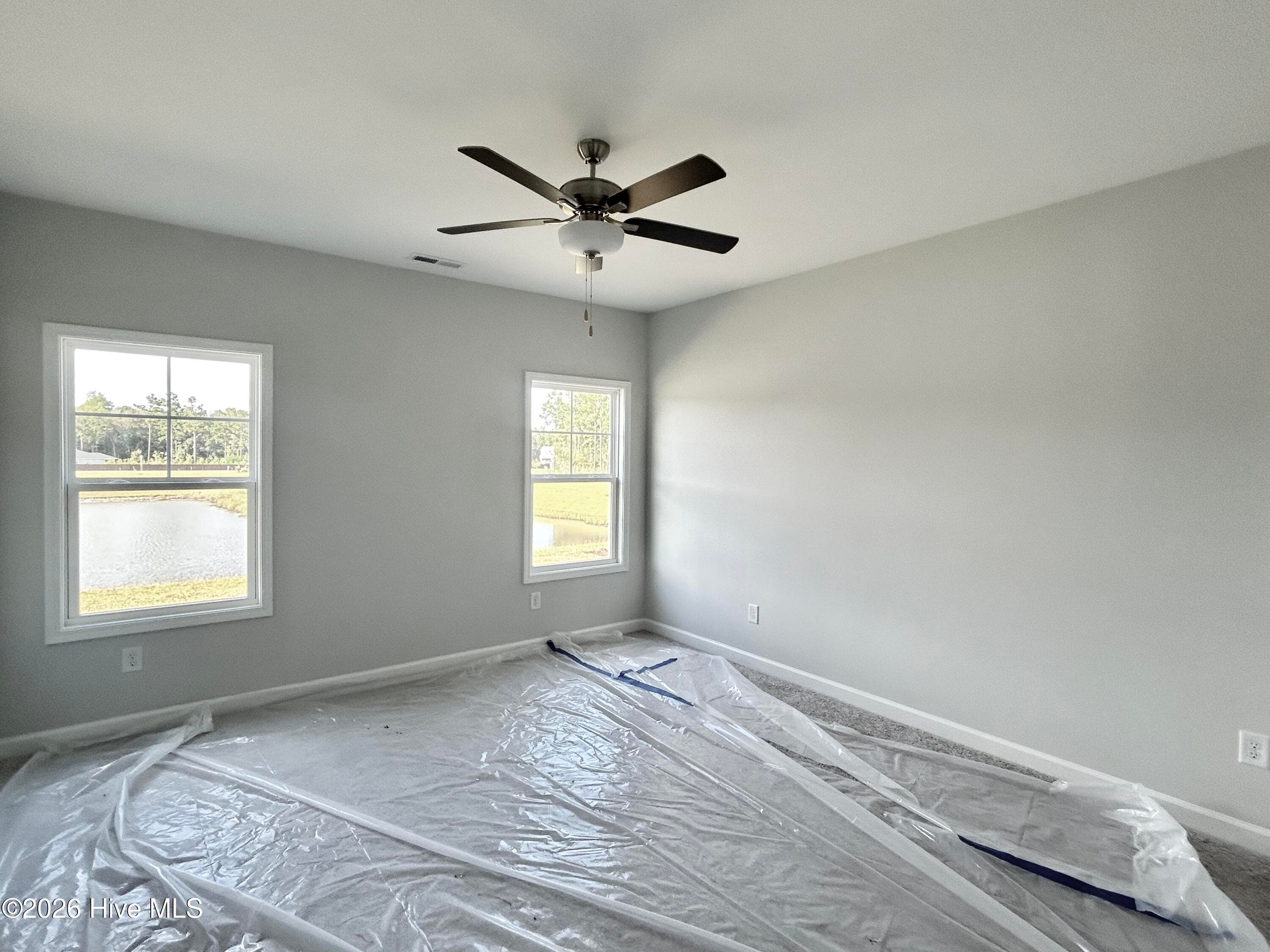 Primary Suite features a Private Bathroom with Tile Shower and Large Walk-in Closet - 9117 Carly Lane 61, Leland, NC 28451