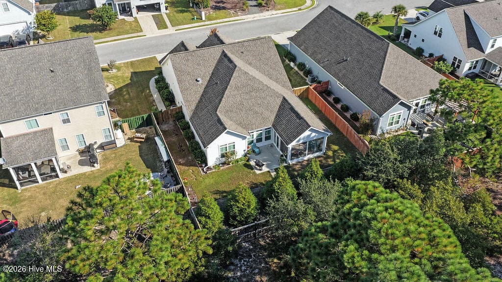 With its extended patio and enclosed 3-season room, this irrigated, beautifully landscaped sloping backyard is easy to maintain. - 142 Rice Marsh Way, Wilmington, NC 28412