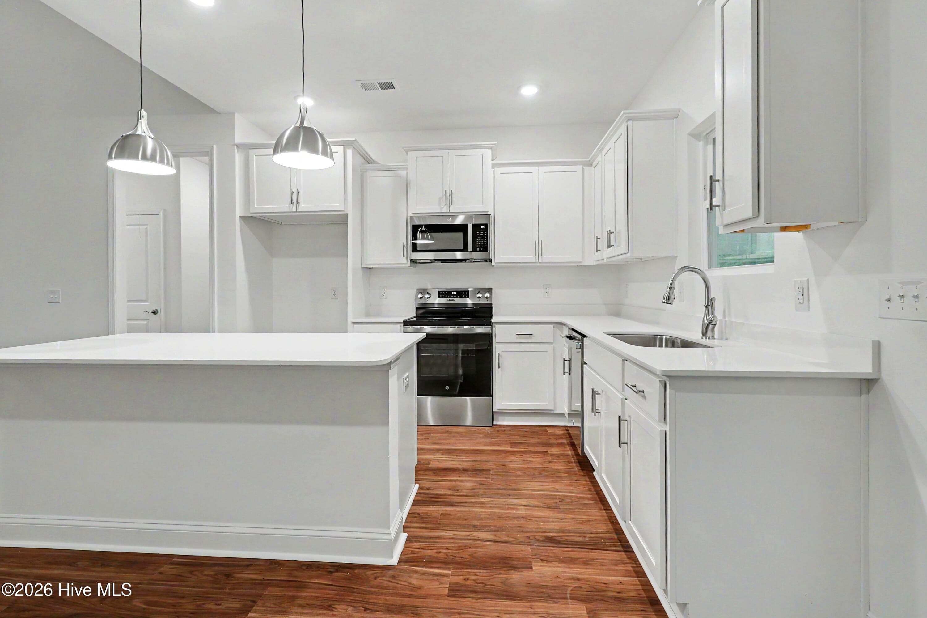 Quartz countertops add a sleek clean look to your Kitchen. - 2111 Cregan Cove SW (Lot 19), Ocean Isle Beach, NC 28469