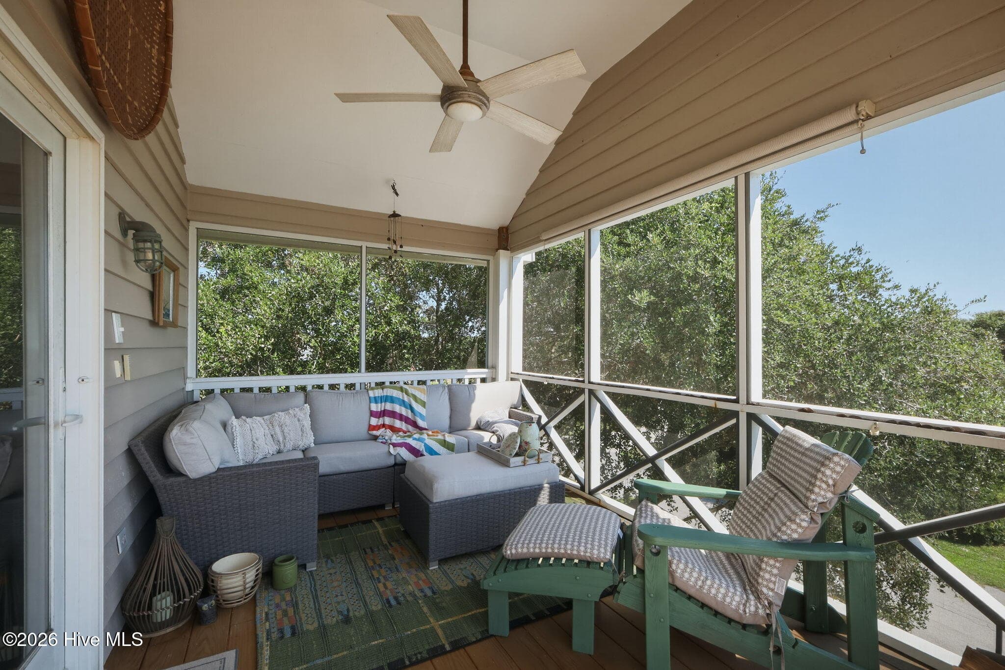 Relax and enjoy the coastal breeze from the spacious screened porch, an ideal extension of the home's living space. - 103 Georgia Street, Emerald Isle, NC 28594