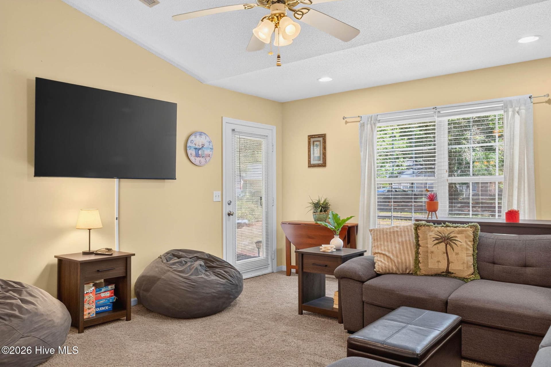 Bright living space with ceiling fan, large window, and plenty of room to gather and unwind. - 1650 Frink Street SW, Ocean Isle Beach, NC 28469