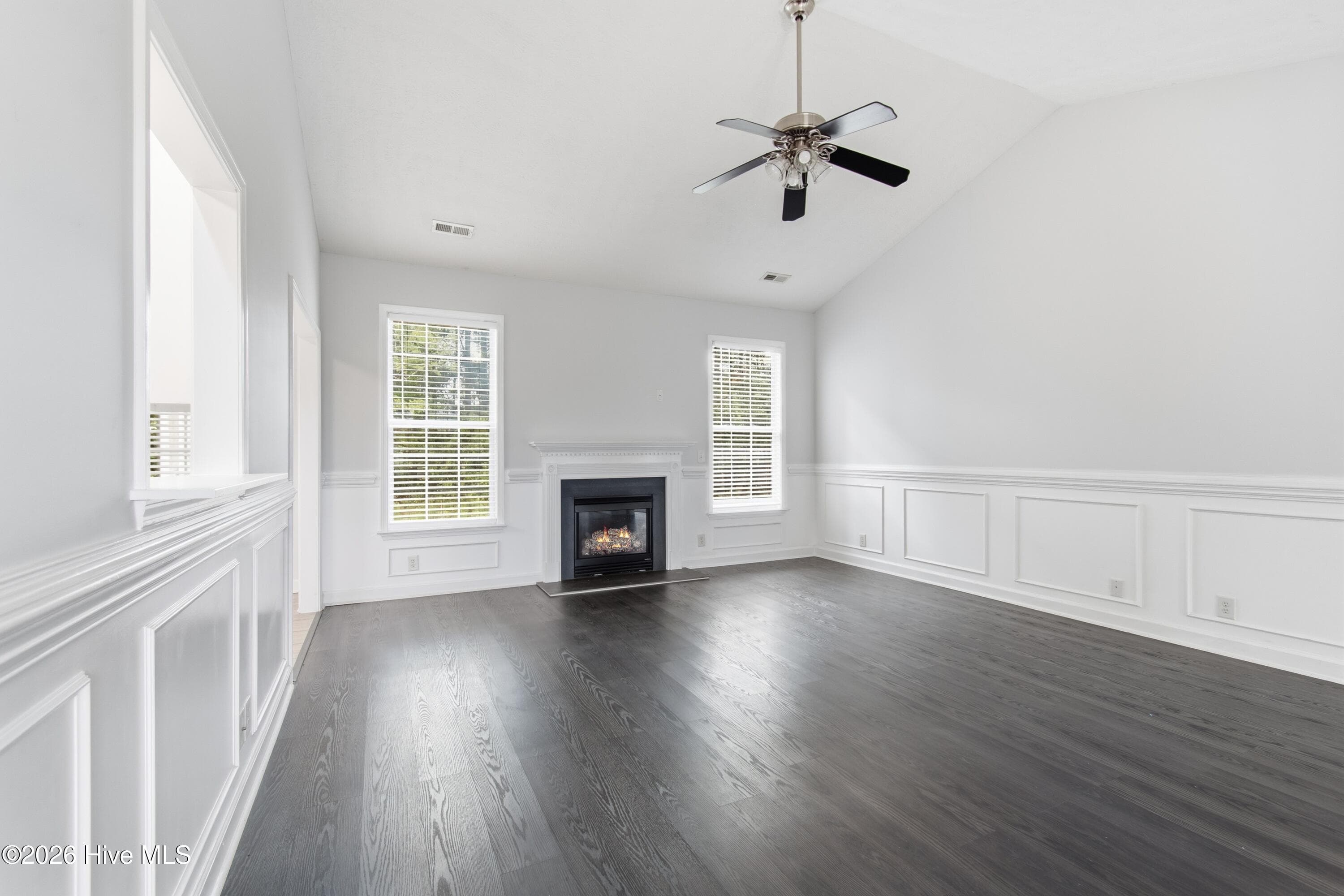 Notice the fireplace and airy feel of the living room. - 709 E Pipers Glen, Shallotte, NC 28470