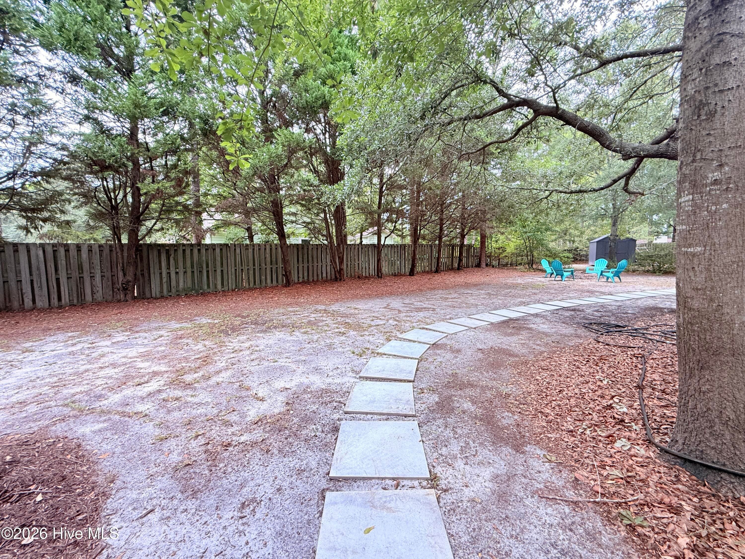 Path leads from the hot tub patio to the fire pit and pool - 1001 Hunting Ridge Road, Wilmington, NC 28412