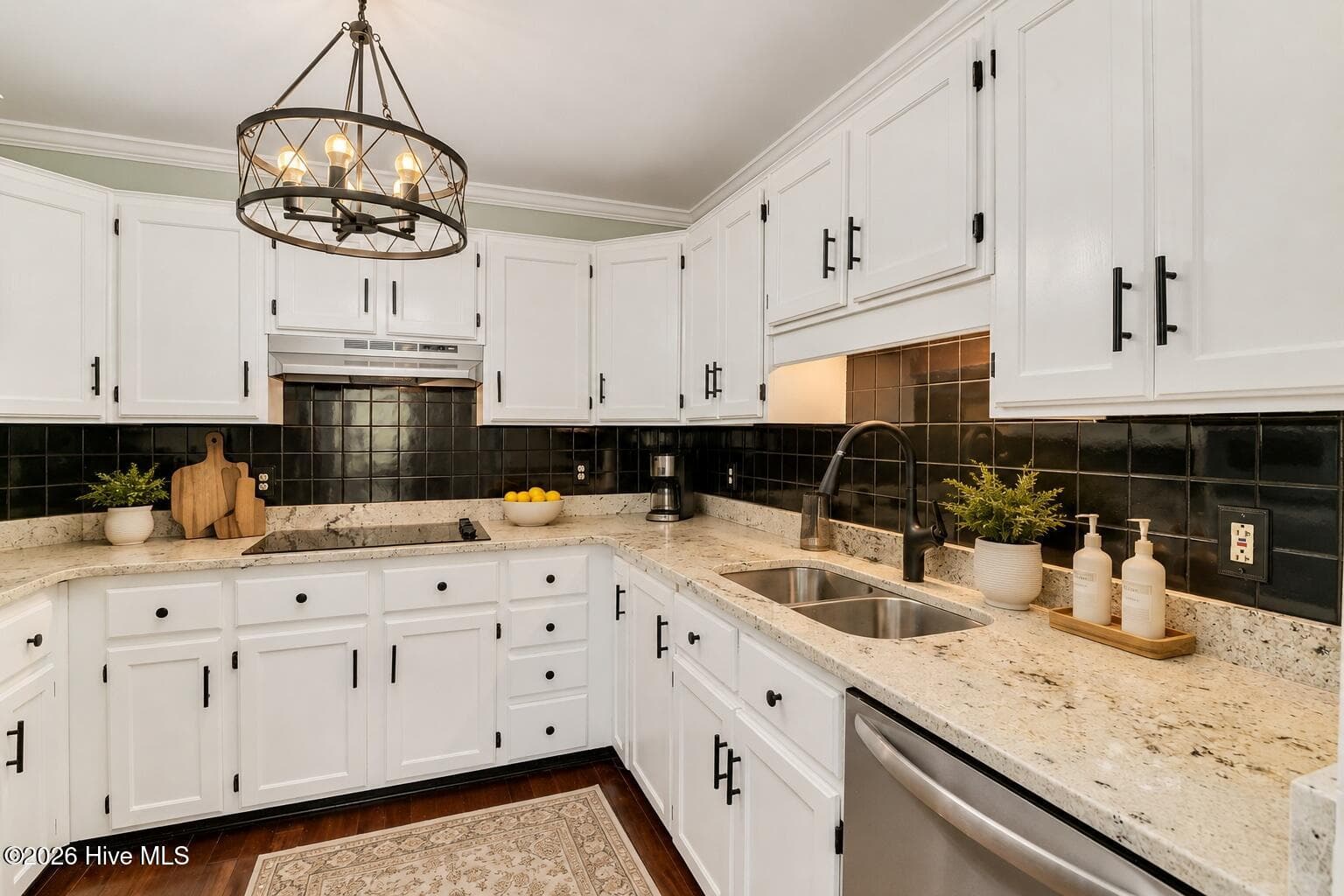 Crisp white cabinetry, black hardware, stone countertops, and a bold backsplash create a kitchen that feels fresh and stylish. - 16 Rapids Court, North Augusta, SC 29841