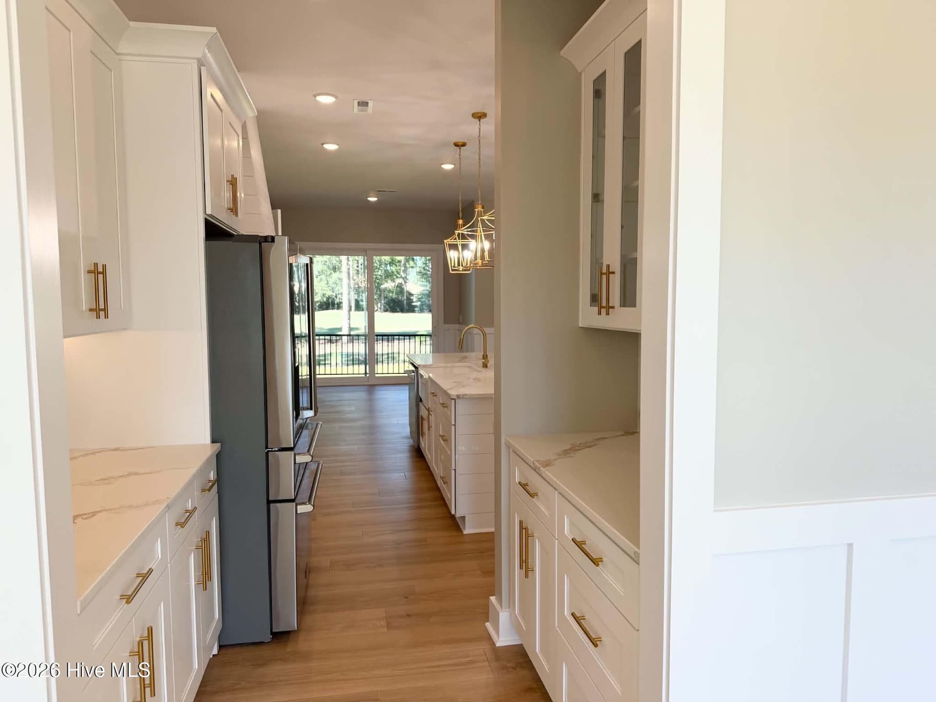 Looking at kitchen area from formal dining room. Custom lighting, counter tops, backsplash, faucet and cabinet hardware. - 550 Glenburnie Street NW, Calabash, NC 28467