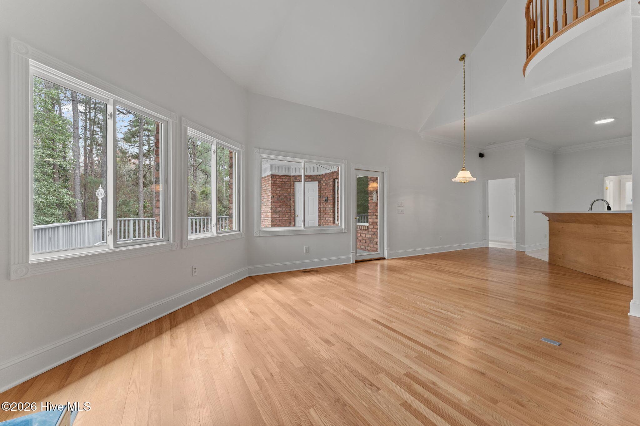 View from the fireplace to the door of the deck and kitchen. - 22 Lochmere Drive, Pinehurst, NC 28374