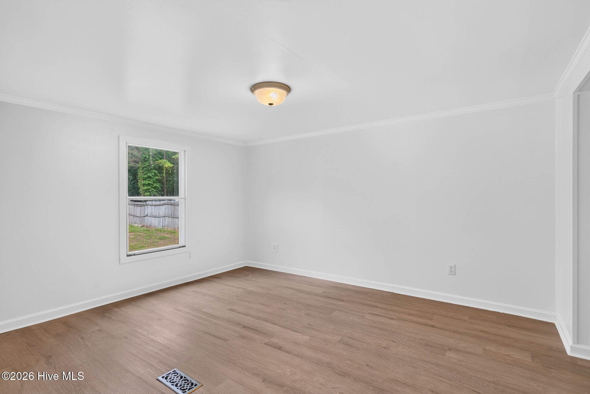 This inviting guest bedroom provides comfortable accommodations with updated finishes and a bright, airy atmosphere. - 1199 Zack Street SE, Bolivia, NC 28422