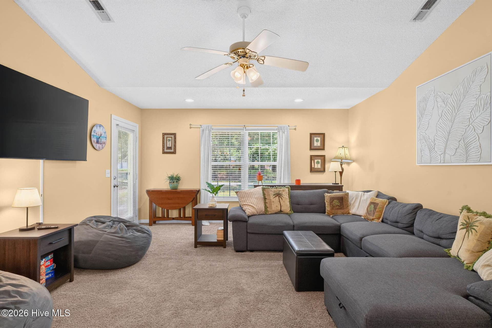 Comfortable living room with abundant natural light and an open connection to the kitchen and dining area. - 1650 Frink Street SW, Ocean Isle Beach, NC 28469
