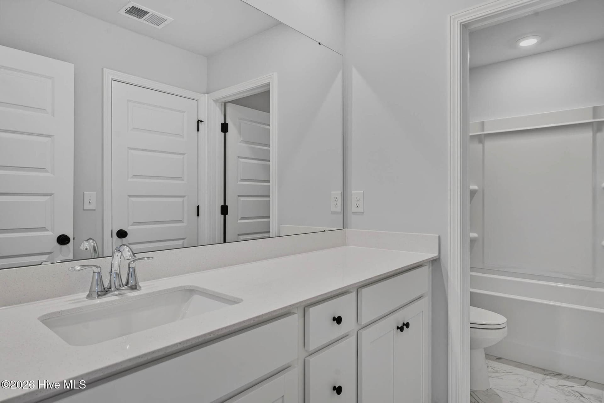Additional view of the upstairs bathroom with double vanities and generous countertop space. - 3447 Sandhill Crane Drive SW, Ocean Isle Beach, NC 28469