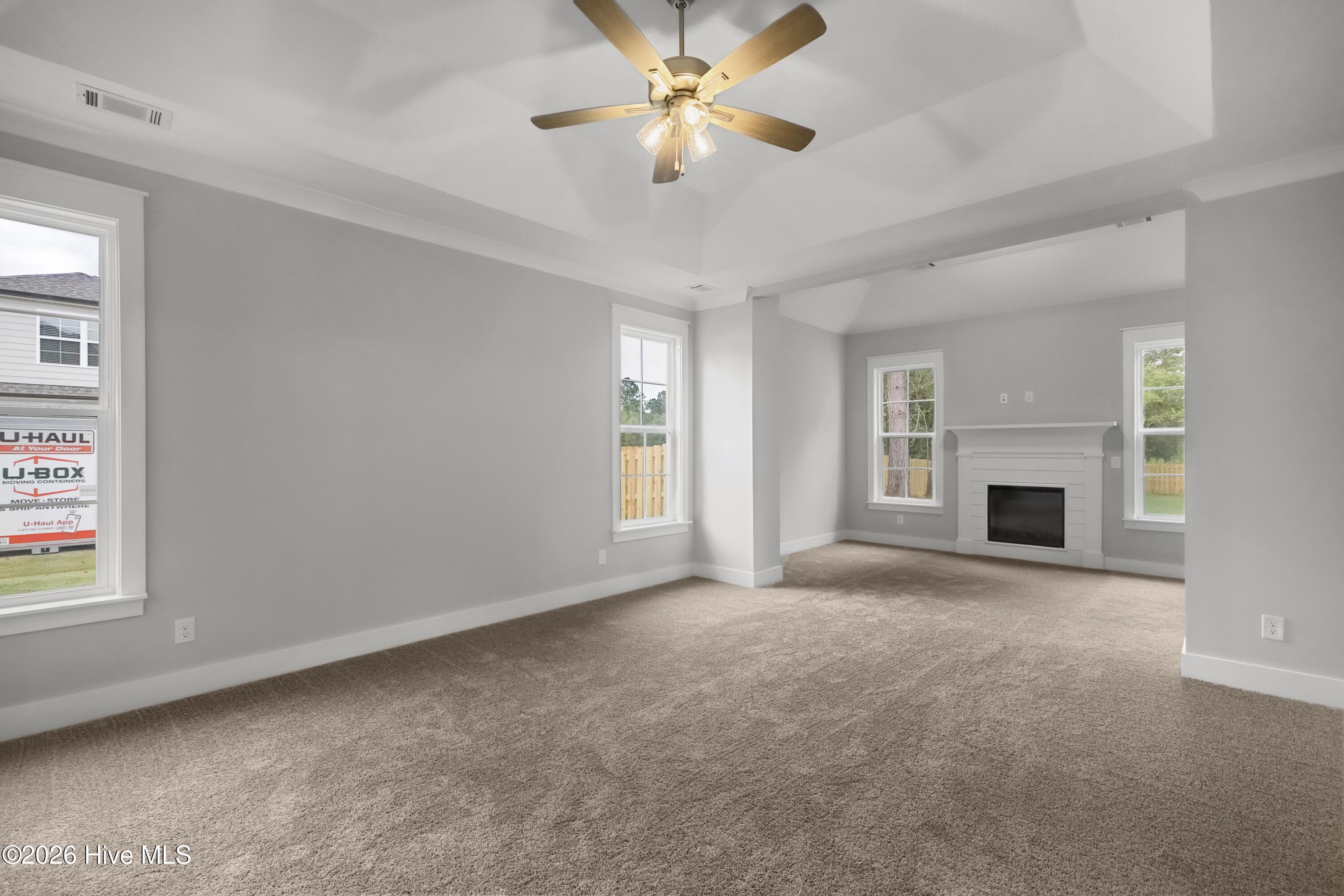 Primary bedroom suite with sitting area and elegant electric fireplace - 1777 Bellingham Drive, Beech Island, SC 29842