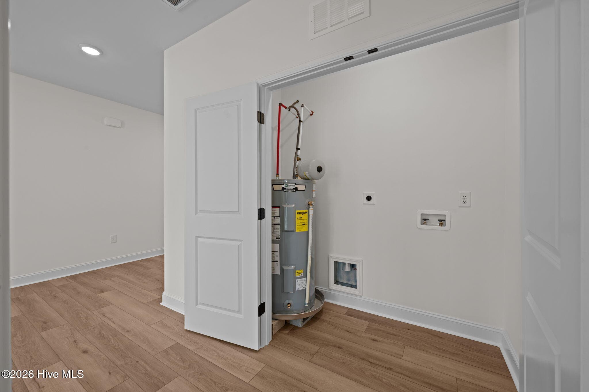 Laundry closet with water heater - 1216 Petite Terre Court, New Bern, NC 28560