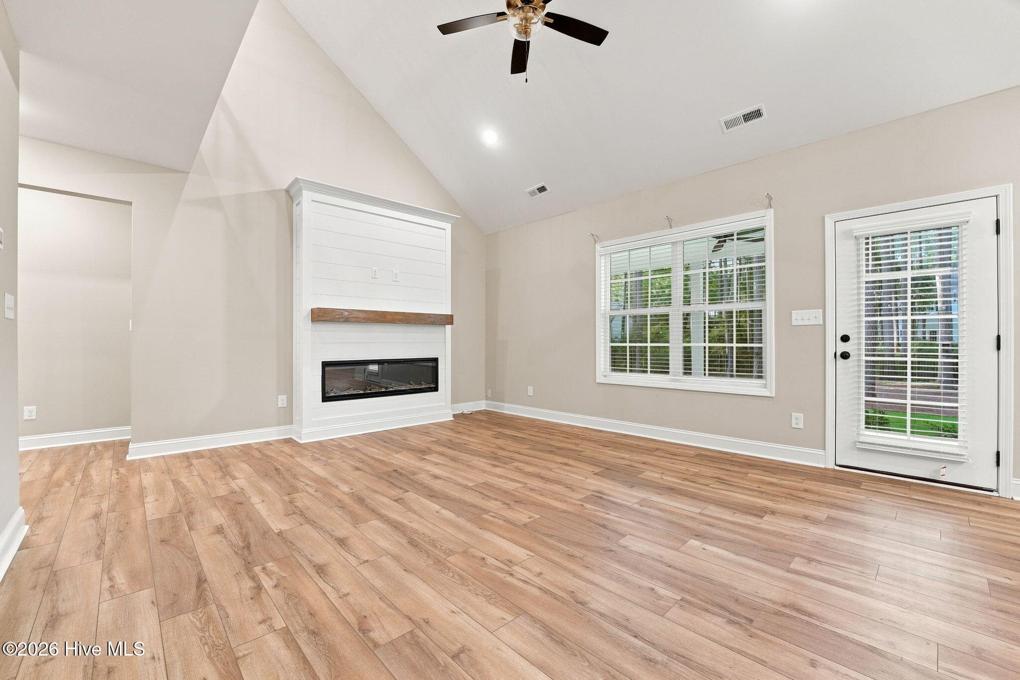 Living area with access to back patio and fenced backyard - 16620 Titmouse Court, Wagram, NC 28396