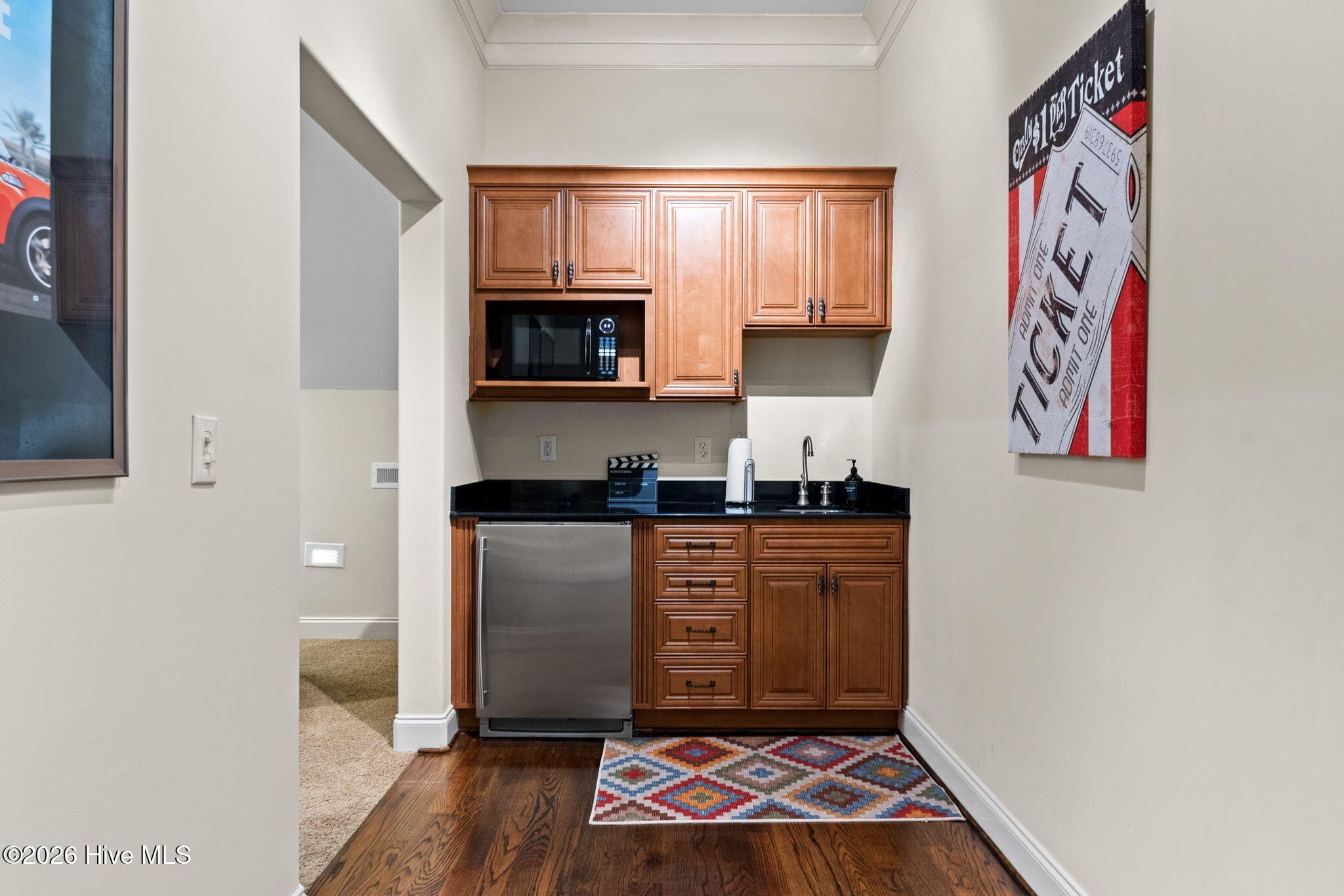 Area outside media room has microwave, sink, storage and small refrigerator - 3858 Ridge Crest Drive, Southport, NC 28461