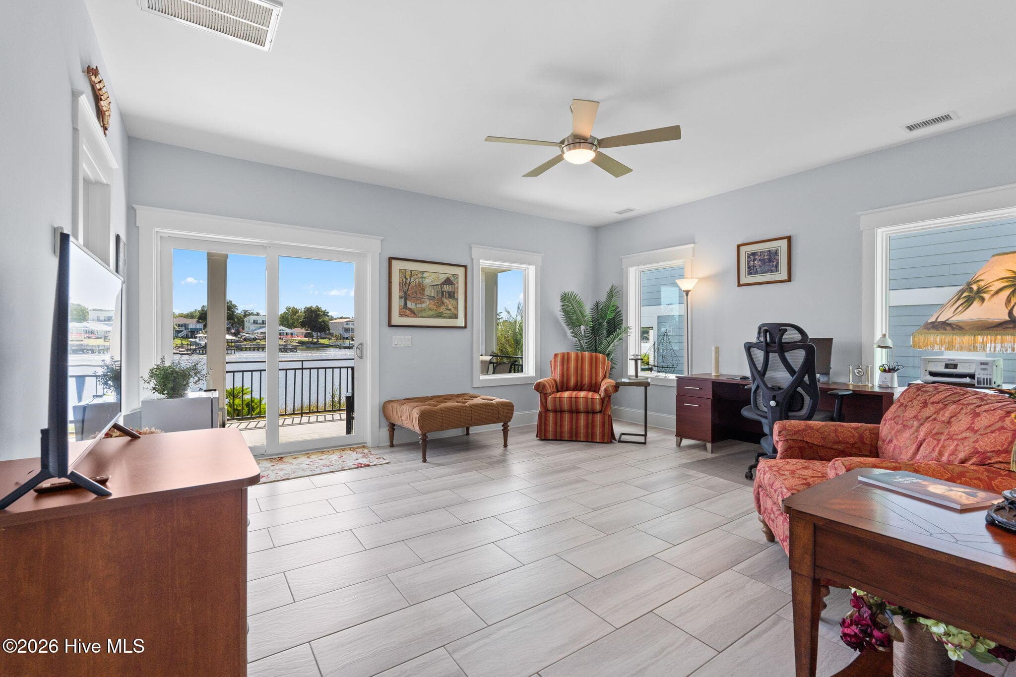 All purpose room has tons of natural light and sliding glass doors to covered lower deck - 2775 Long Bay Drive SE, Southport, NC 28461