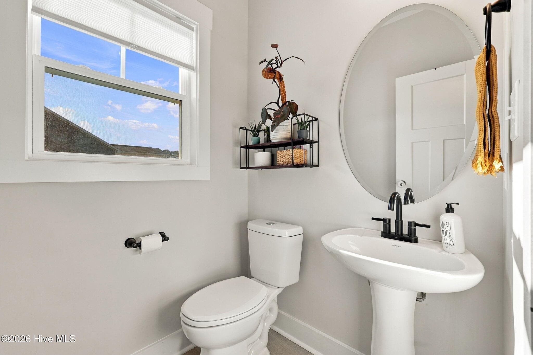 Downstairs 1/2 bath with a plethora of natural light. - 1400 Chason Road, Lumber Bridge, NC 28357
