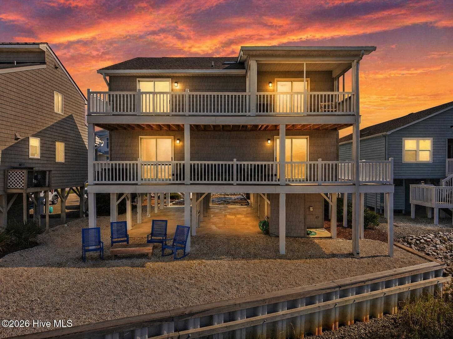 Twilight photo of the back exterior of 1206 N Shore Drive W. - 1206 N Shore Drive W, Sunset Beach, NC 28468