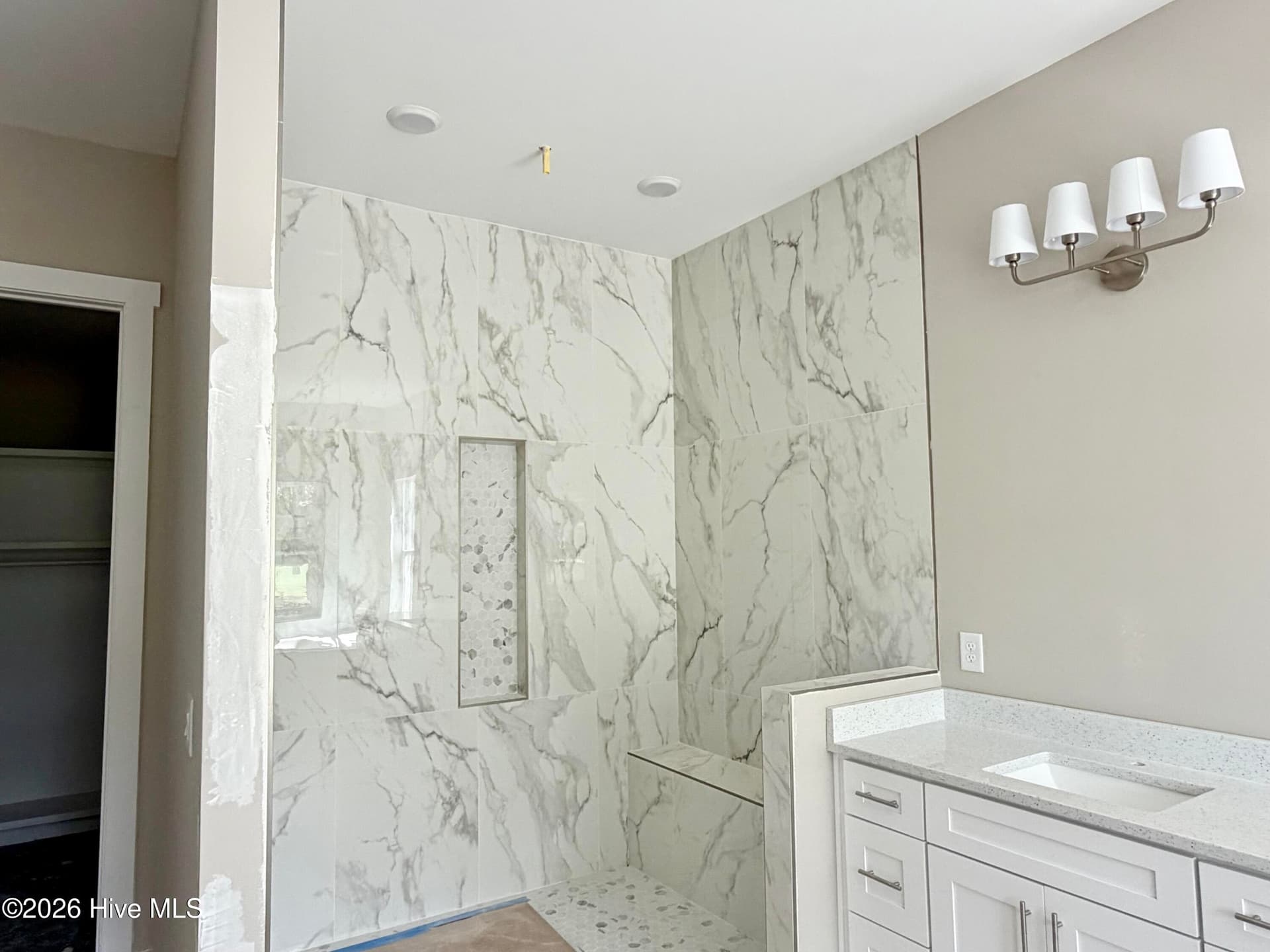 Primary bath, under construction. Shower doors and all fixtures to be installed. To include rain shower head. - 550 Glenburnie Street NW, Calabash, NC 28467