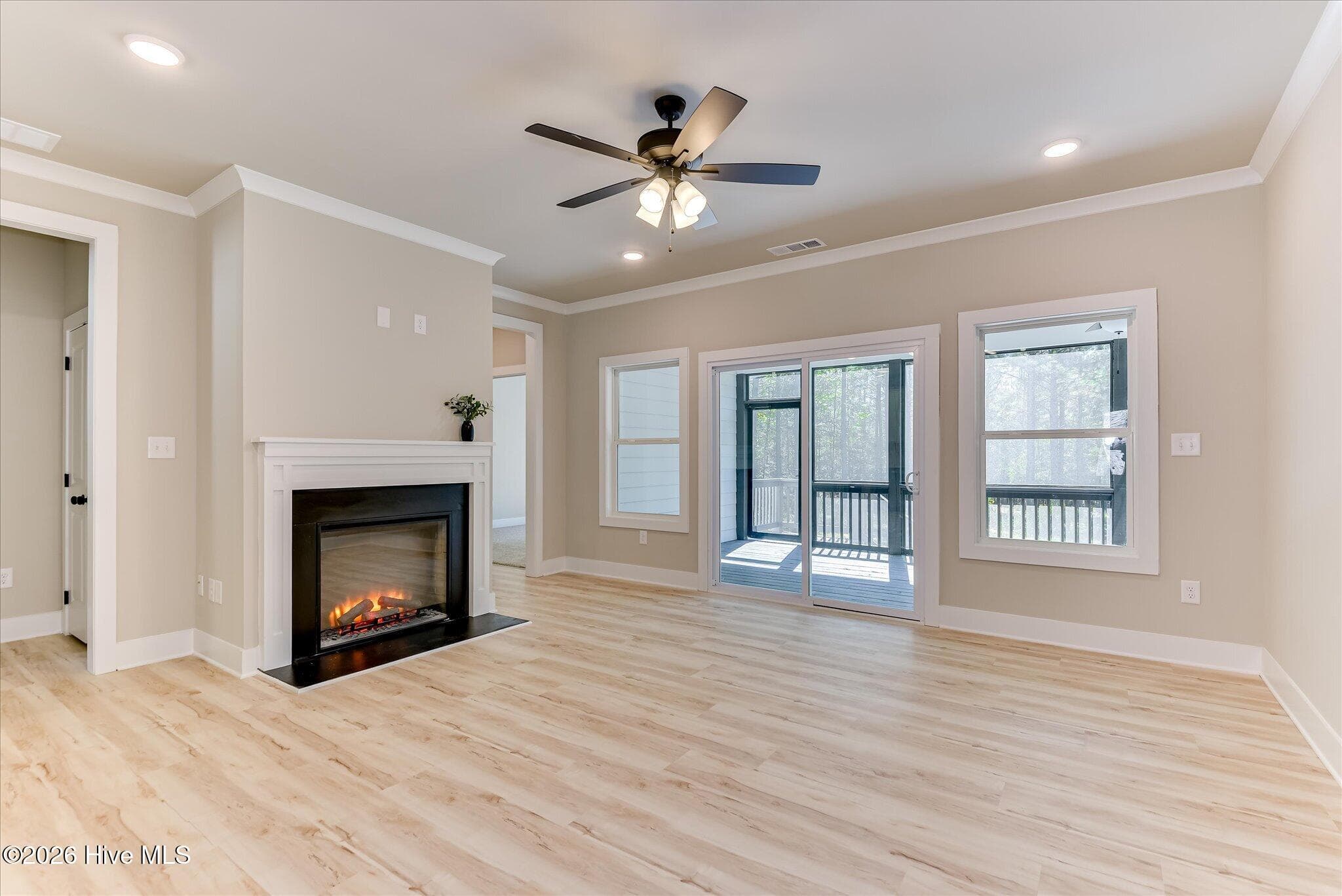 Electric fireplace with sliding doors to rear screened porch - 1198 Sunset Cove, Tignall, GA 30668