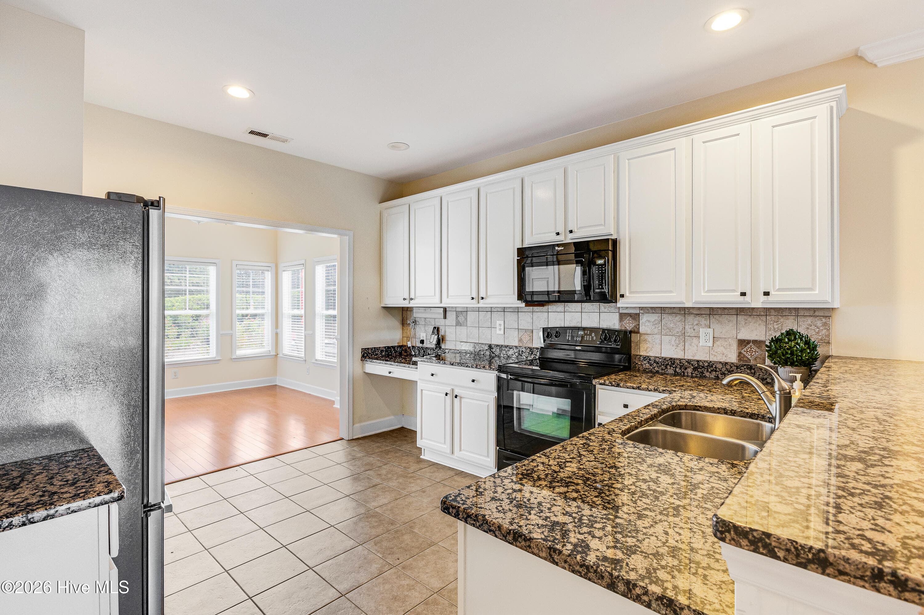 Spacious kitchen leading to the heated and cooled sunroom! - 4020 Norseman Loop Unit 2, Southport, NC 28461