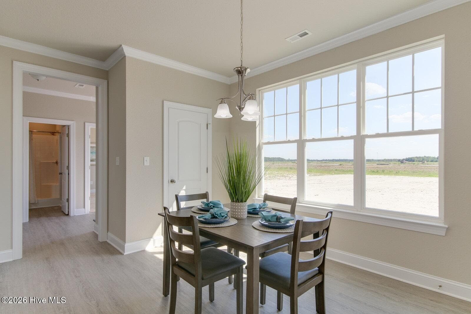 Sample photo shows kitchen eat-in area; note large triple windows - 122 Arbormoor Lane, Moyock, NC 27958