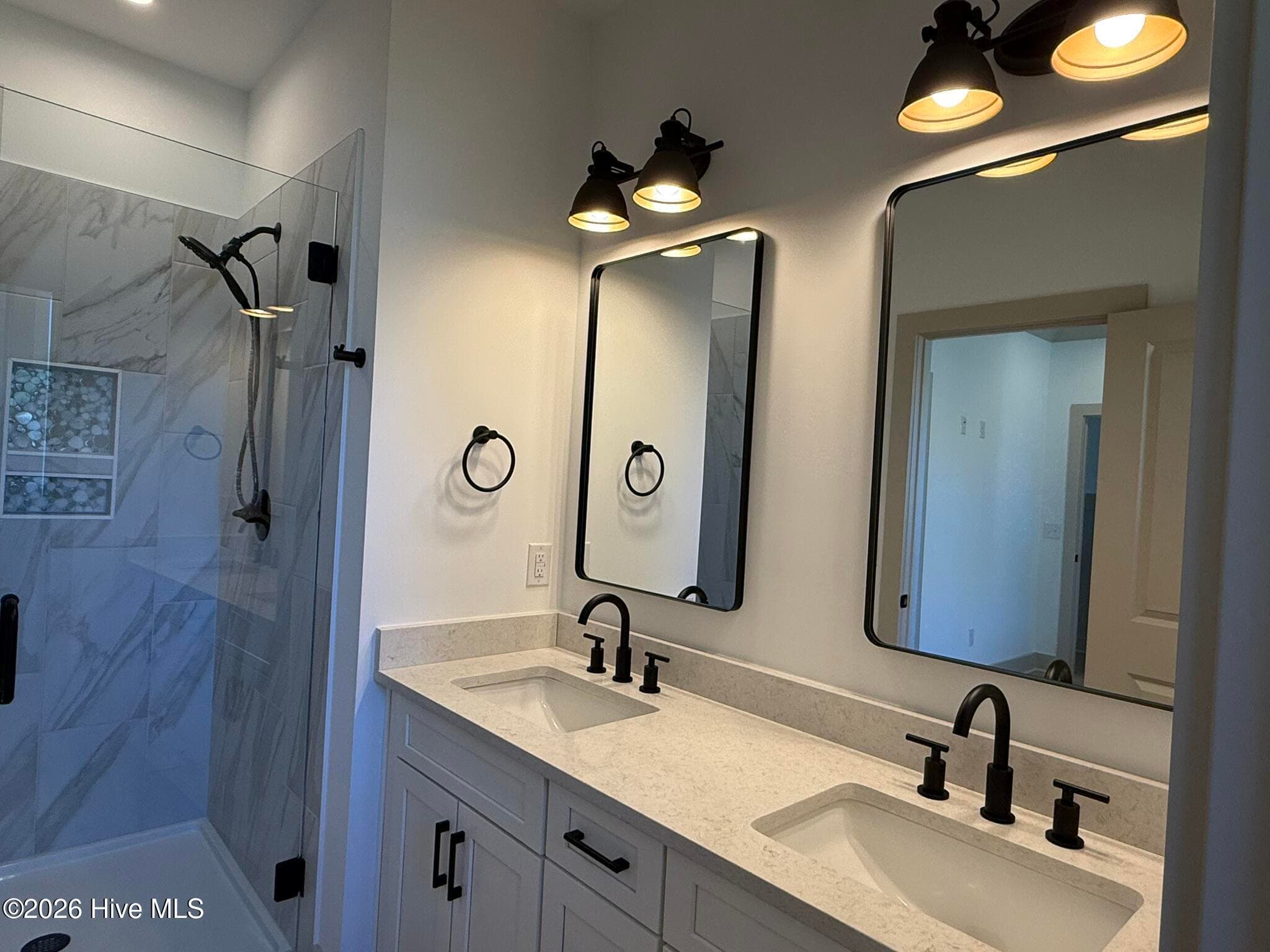 Both primary suiotes are downstairs with a private bath and double sinks - 254 NE 66th Street, Oak Island, NC 28465