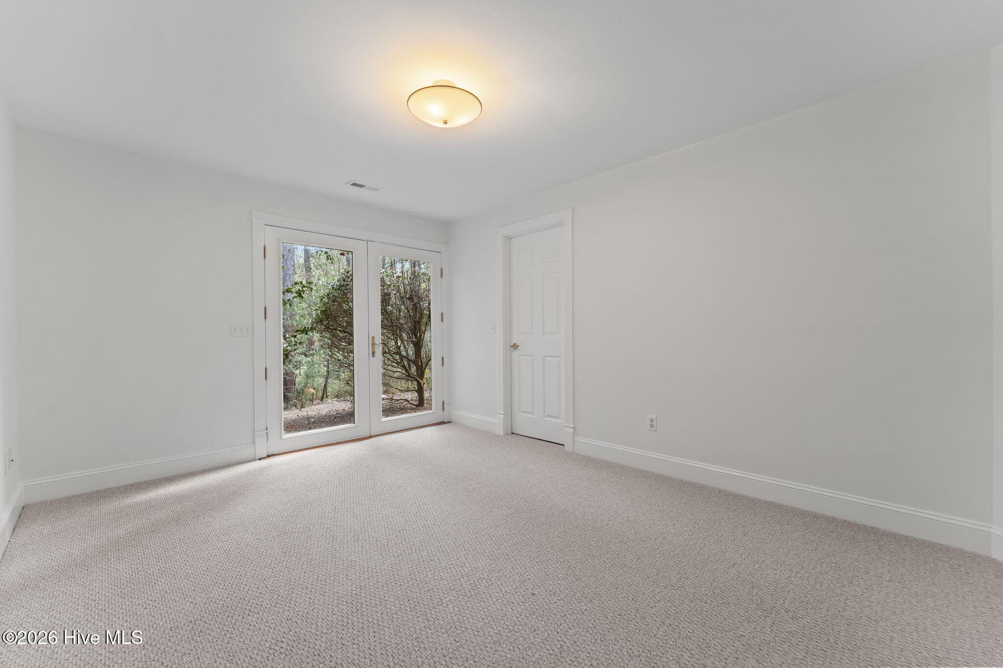 Bedroom #4 lower level with access to the backyard. - 22 Lochmere Drive, Pinehurst, NC 28374