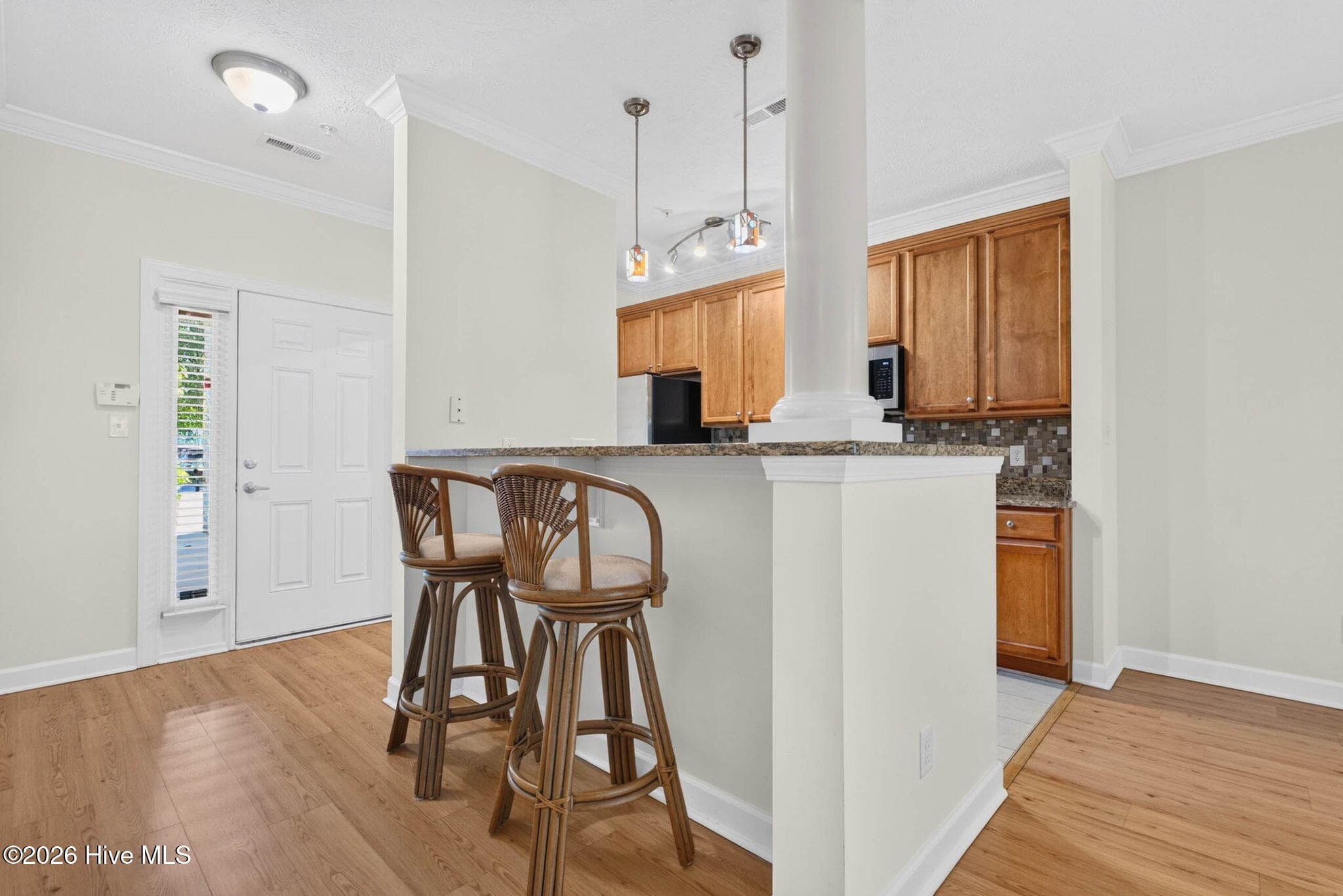 Kitchen bar top with view of foyer and front door - 7825 High Market Street #303, Sunset Beach, NC 28468