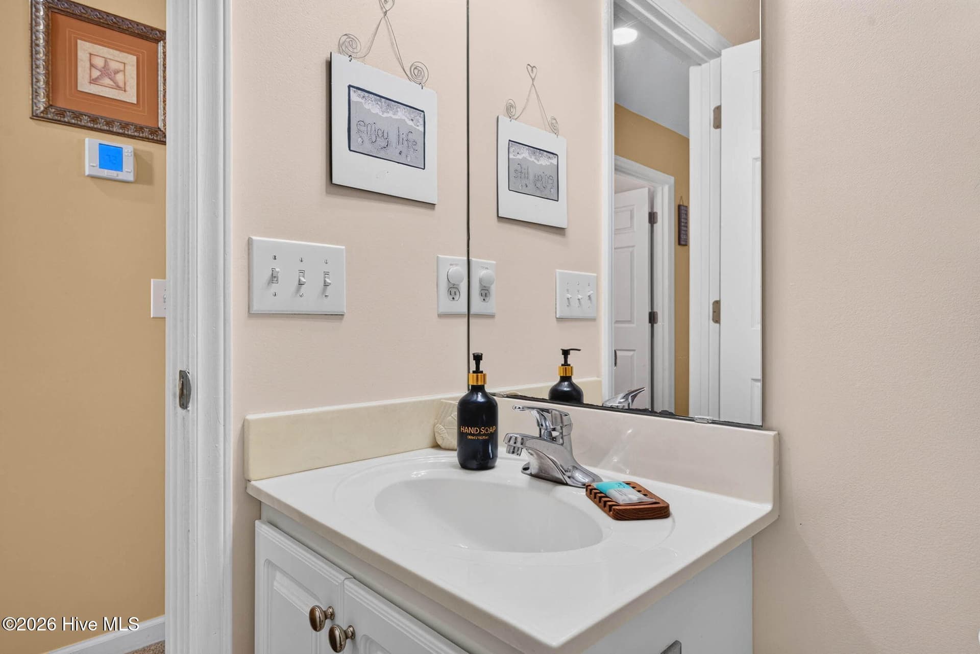 Bright guest bath with vanity storage and a clean, functional design. - 1650 Frink Street SW, Ocean Isle Beach, NC 28469