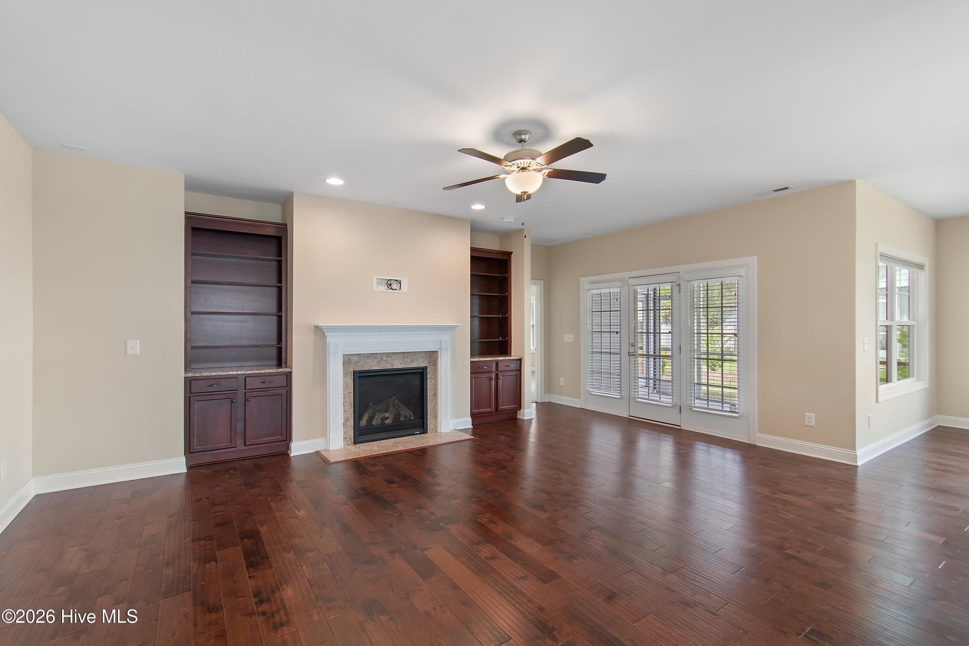 Notice the beautiful wood floors, built-in cabinets and fireplace in the living room. - 1674 Back Bay Drive SW, Shallotte, NC 28470