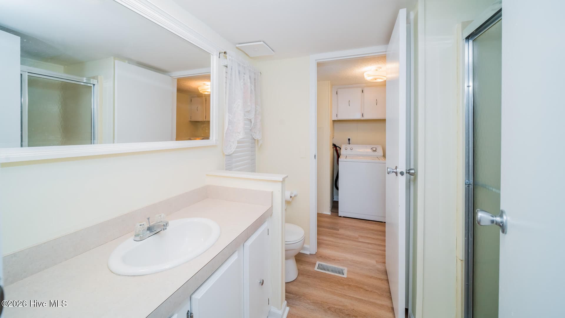 The primary bath offers lots of counter space, a walk in shower, and is conveniently located adjacent to the laudry room. - 1076 Clubview Lane SW, Calabash, NC 28467