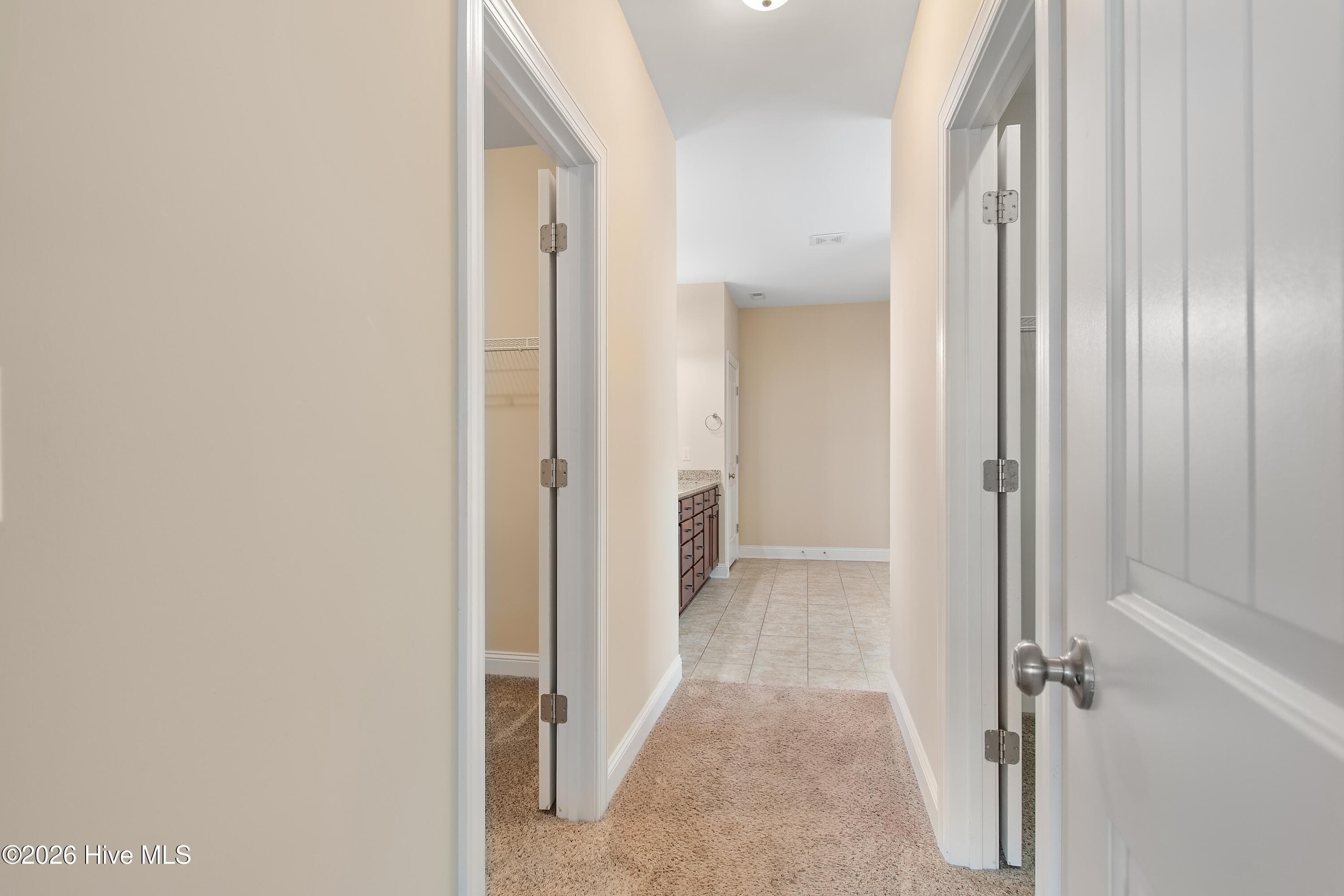 Primary suite hallway from bathroom to bedroom. - 1674 Back Bay Drive SW, Shallotte, NC 28470