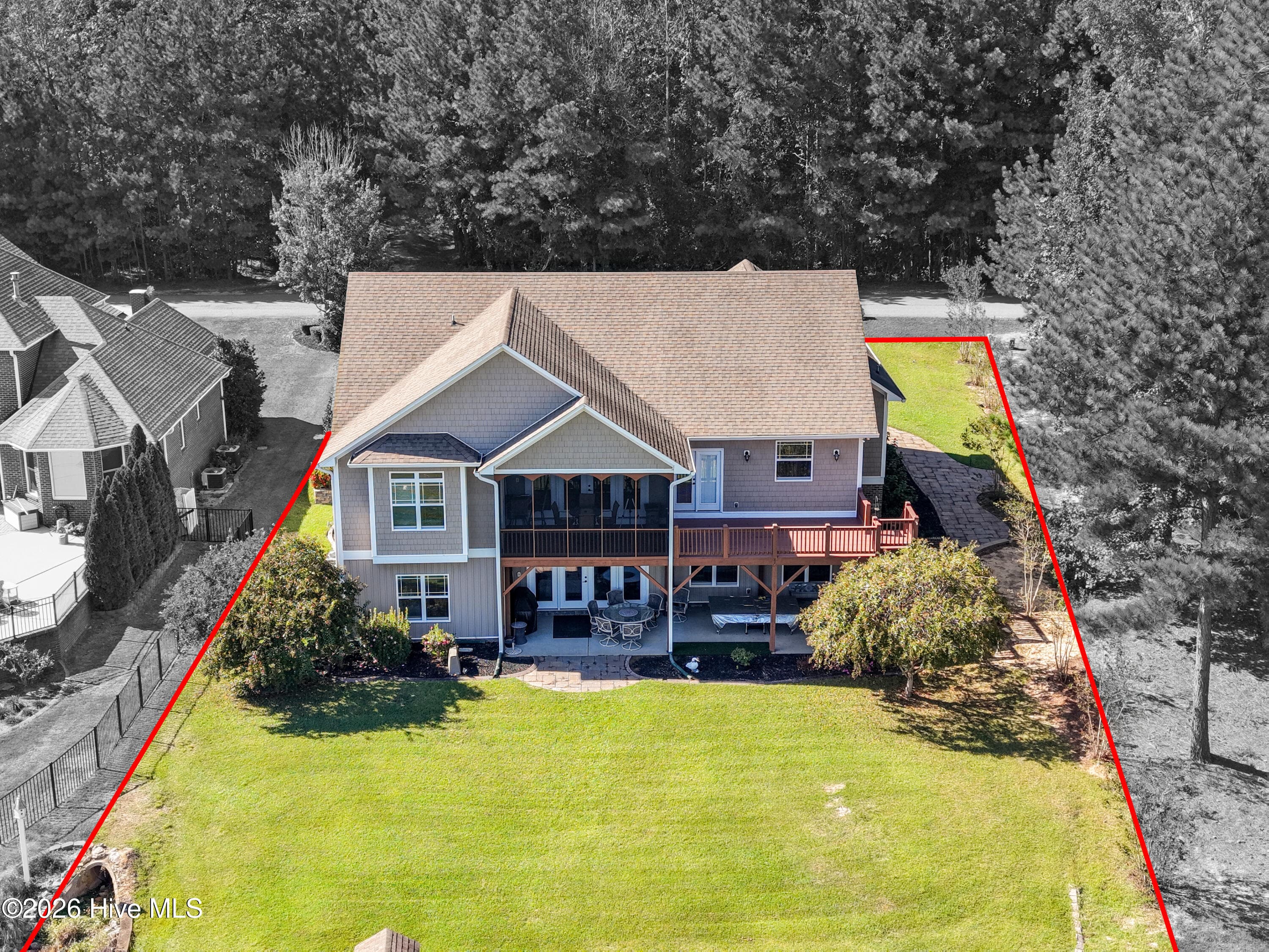 Rear aerial view of 899 Seagull Drive, highlighting the home and backyard. Property boundary lines are digitally added and approximate, for illustrative purposes only. They do not constitute a survey. Buyers are encouraged to verify property boundaries through recorded documents and a current survey as part of their due diligence. - 899 Seagull Drive, Vass, NC 28394, Vass