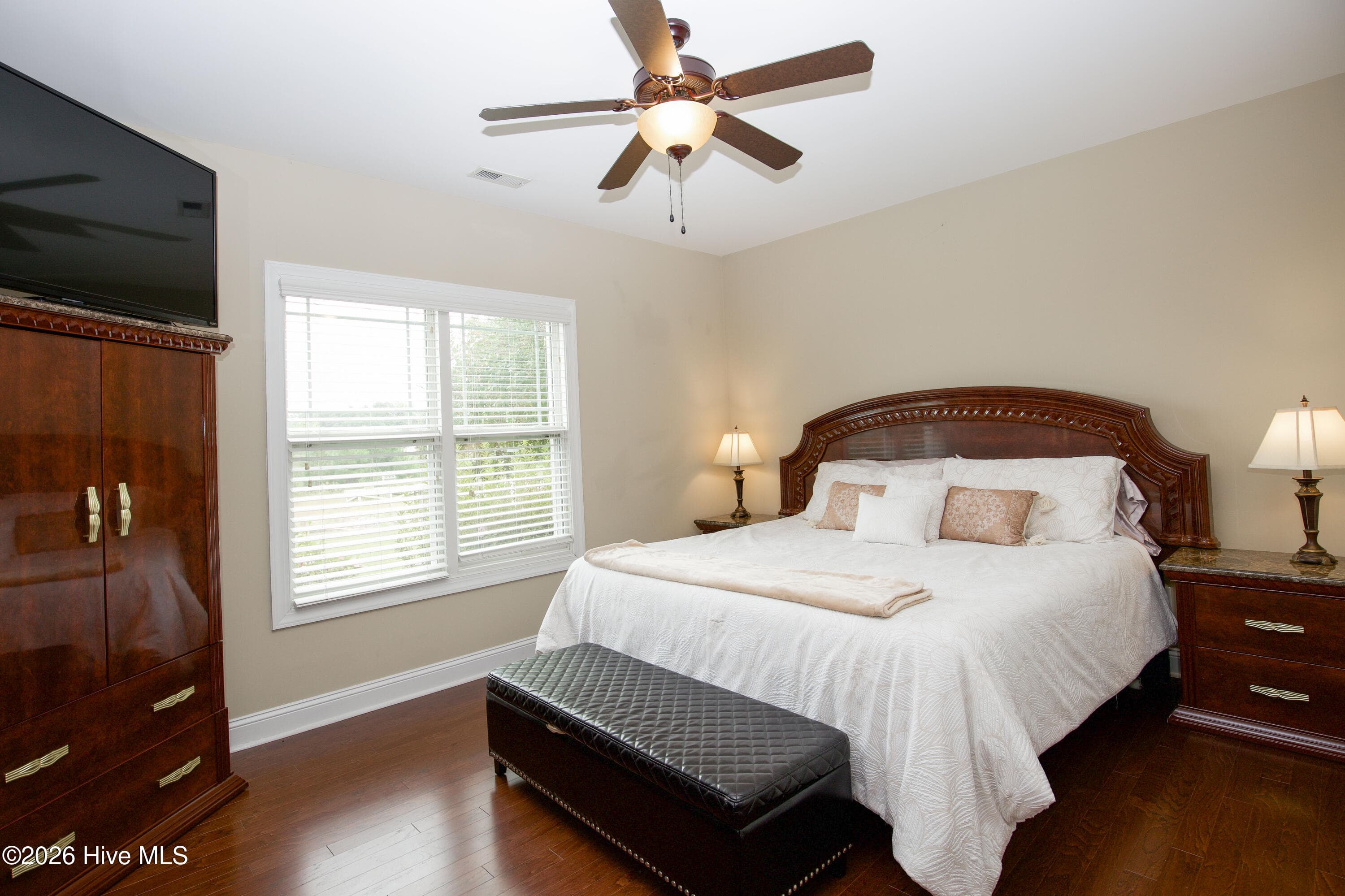 Lower-level bedroom with a ceiling fan and window. - 899 Seagull Drive, Vass, NC 28394, Vass