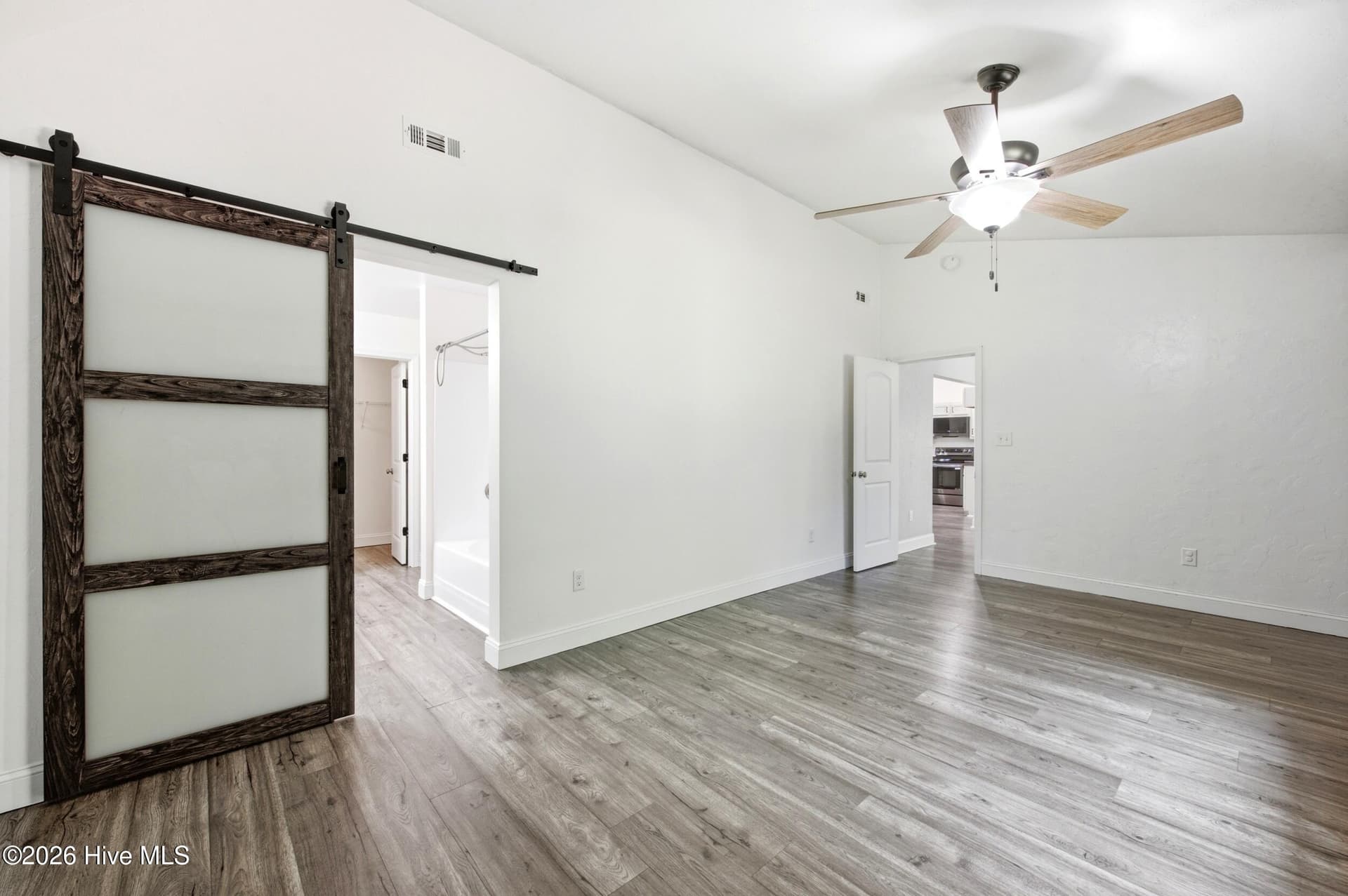 Primary Bedroom to the bath - 122 Pond View Circle, Hampstead, NC 28443