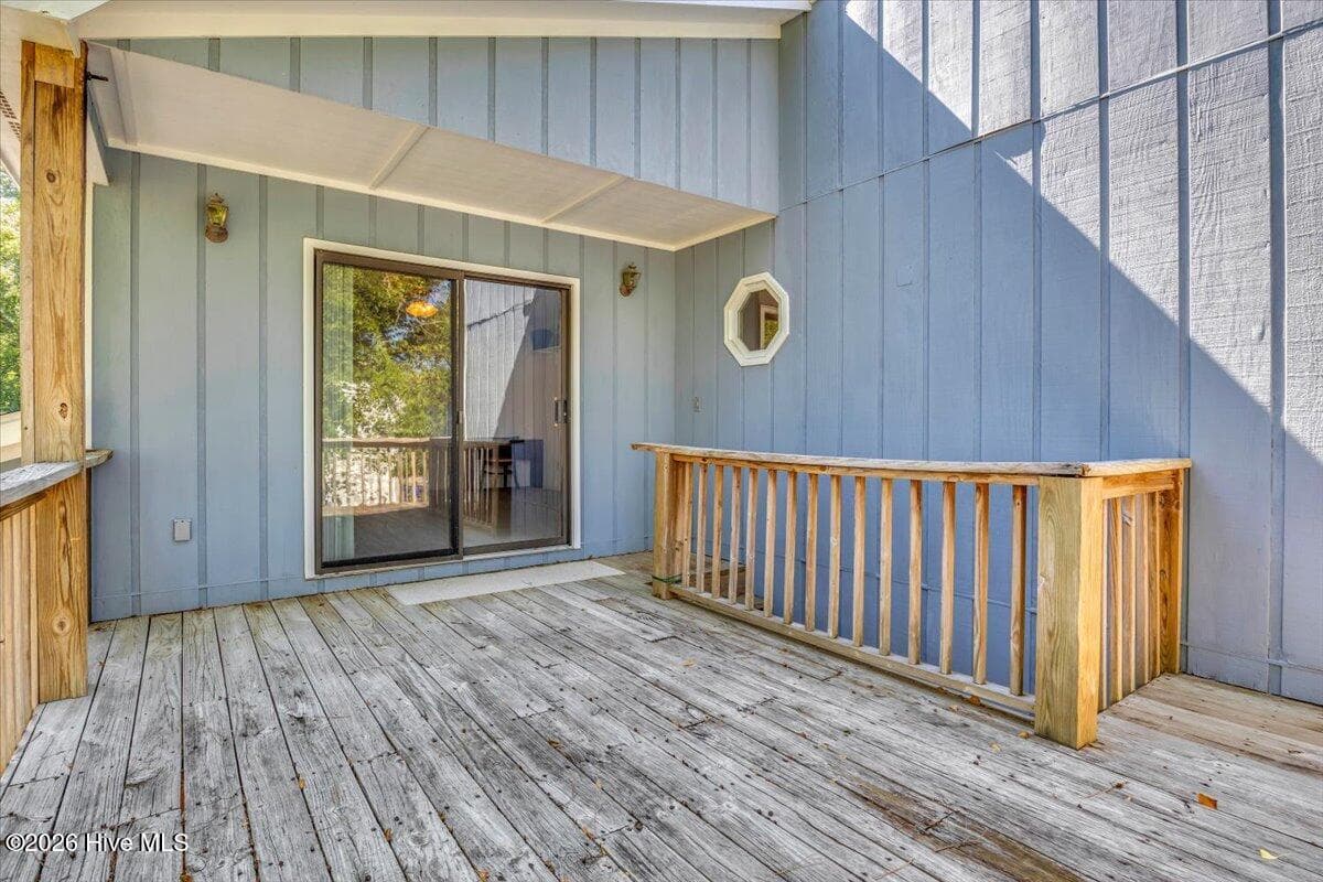 Upper deck with stairs down to patio area and door to mudroom - 109 NE 30th Street, Oak Island, NC 28465