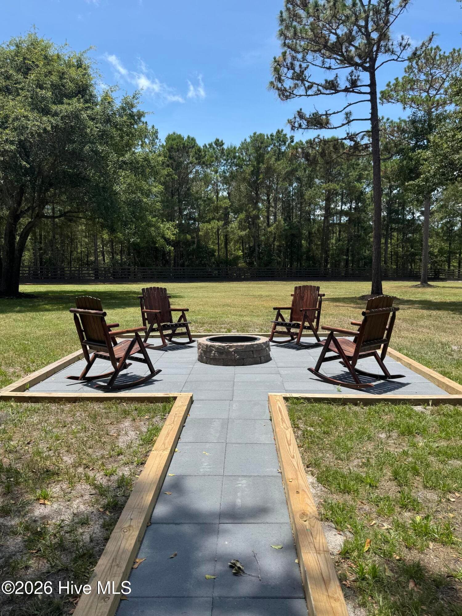 Enjoy cool summer nights and the coming fall afternoons around the fire pit - 1265 Gilbert Road SE, Bolivia, NC 28422
