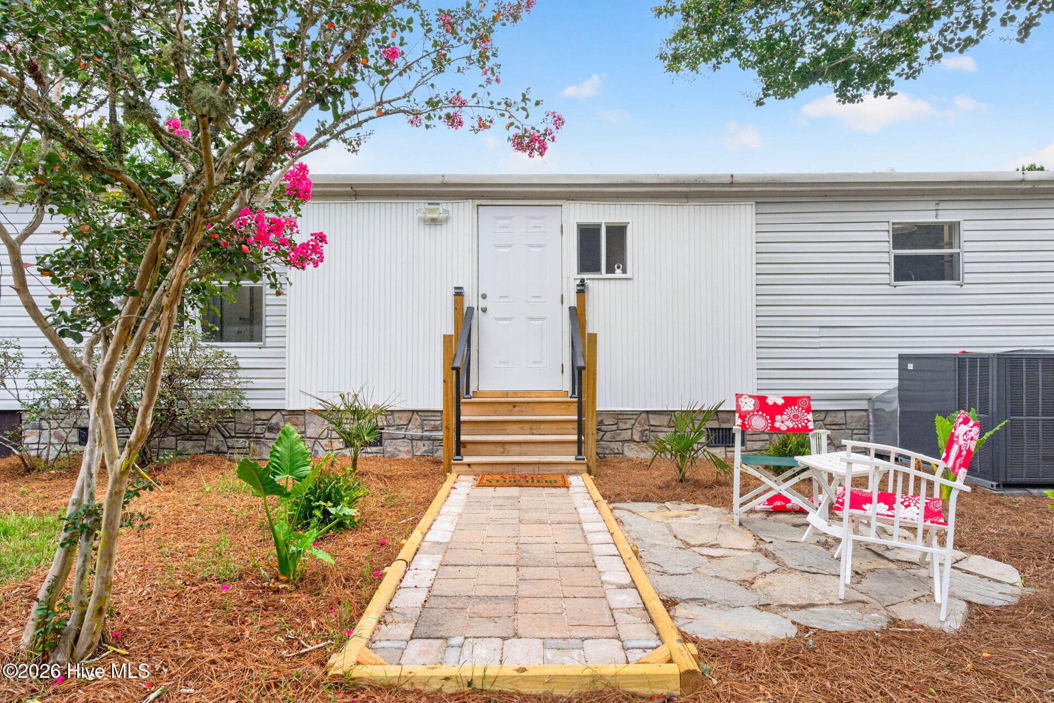 The rear of the home features a welcoming patio overlooking the landscaped backyard, creating the perfect space for outdoor gatherings and everyday enjoyment. - 1199 Zack Street SE, Bolivia, NC 28422